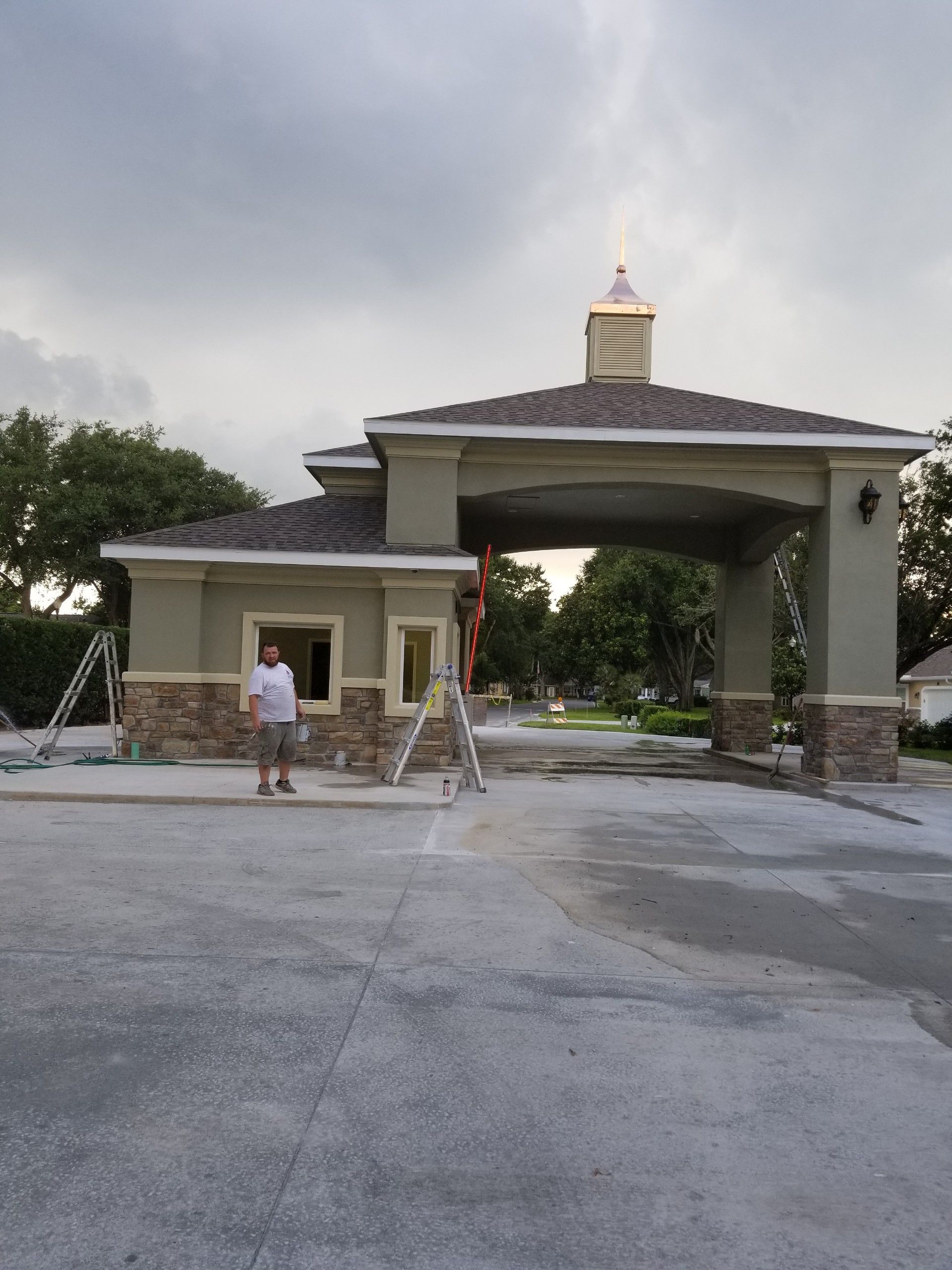 A man is standing in front of a building that is under construction