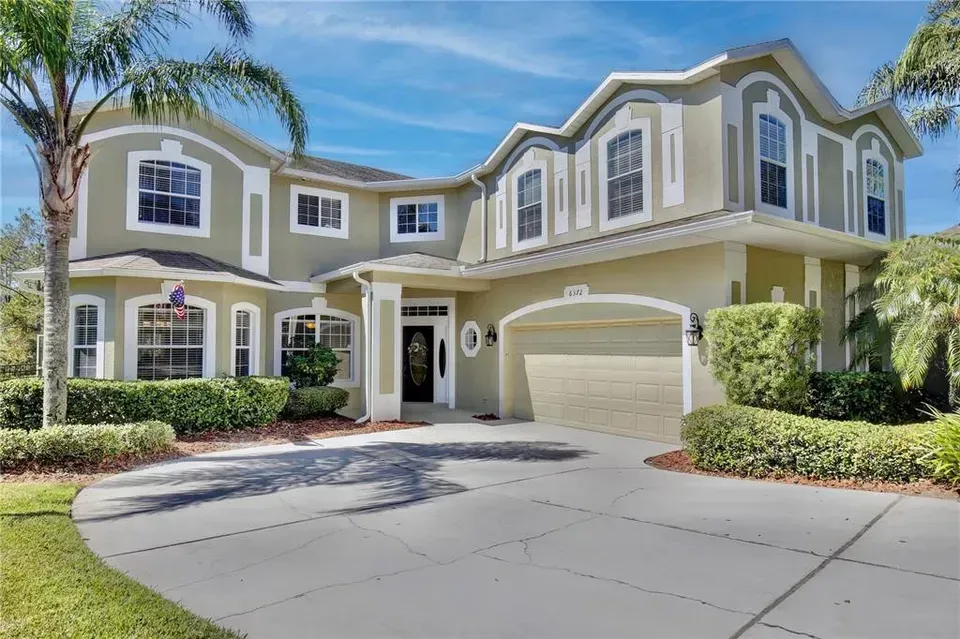 A large house with a palm tree in front of it