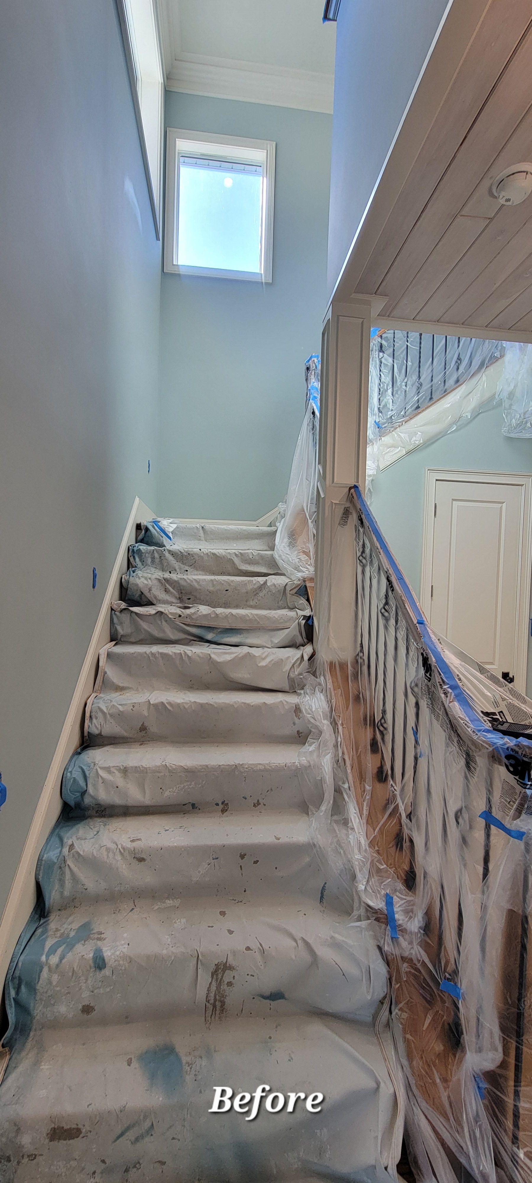A picture of a staircase before being painted.