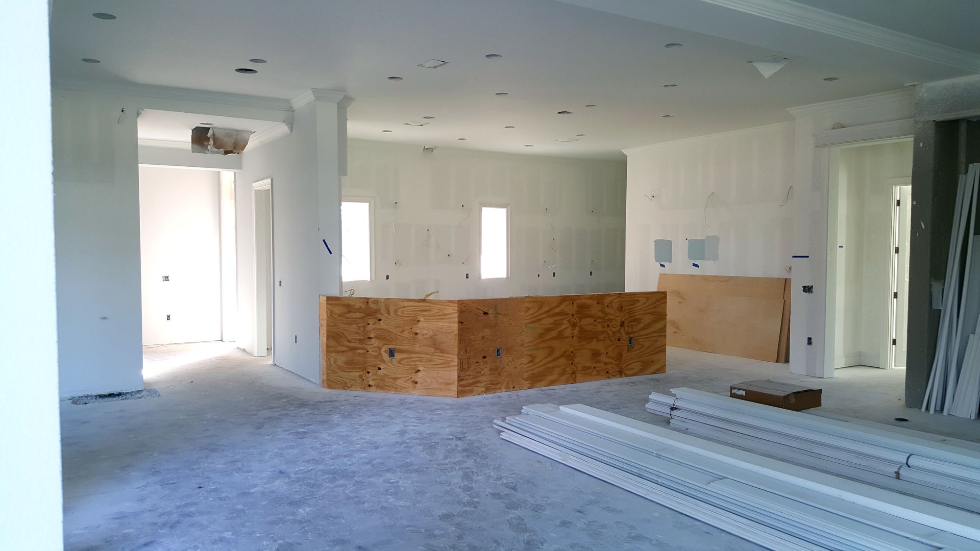 An empty room with a wooden counter in the middle