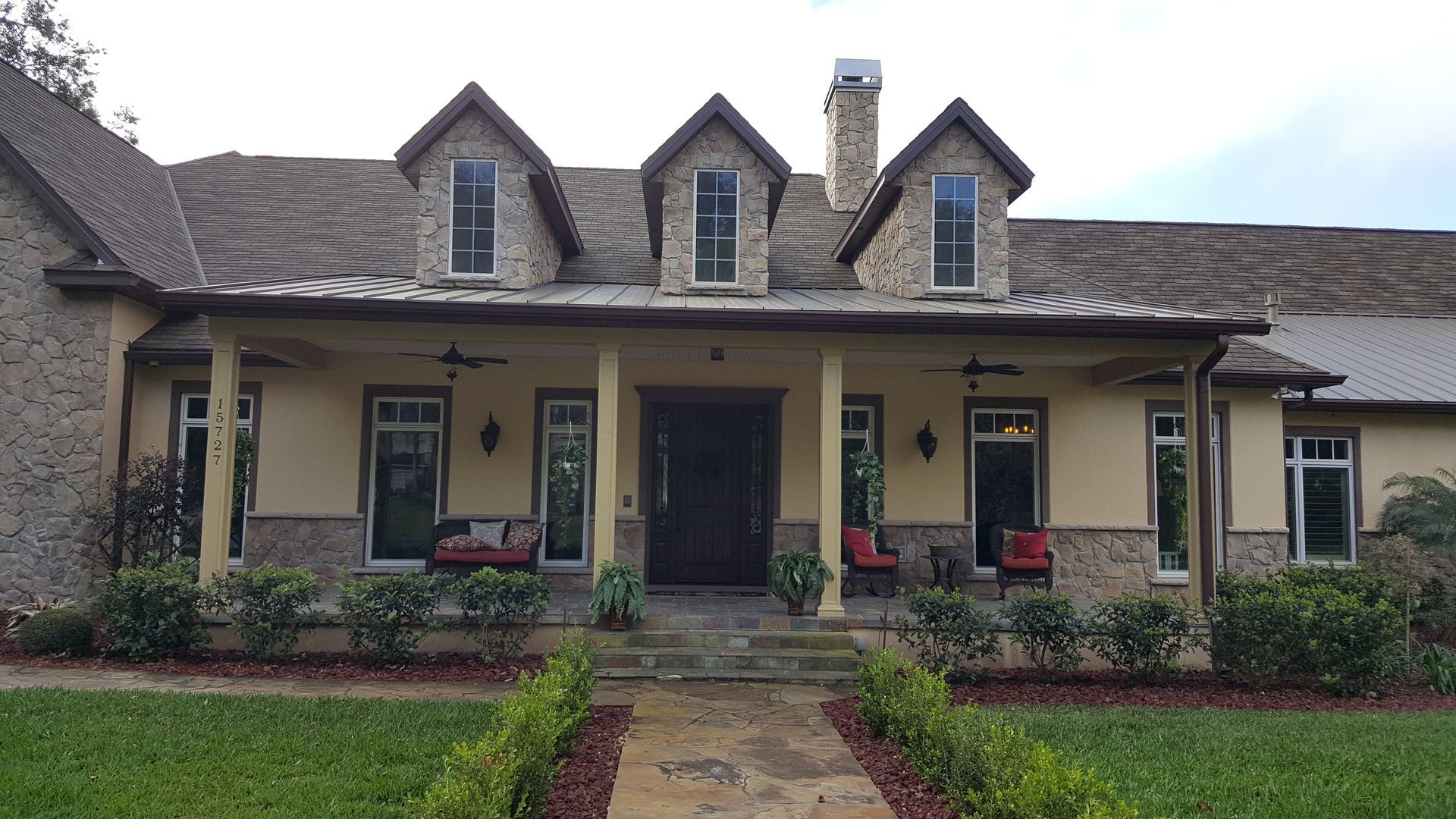 A large house with a porch and a walkway leading to it