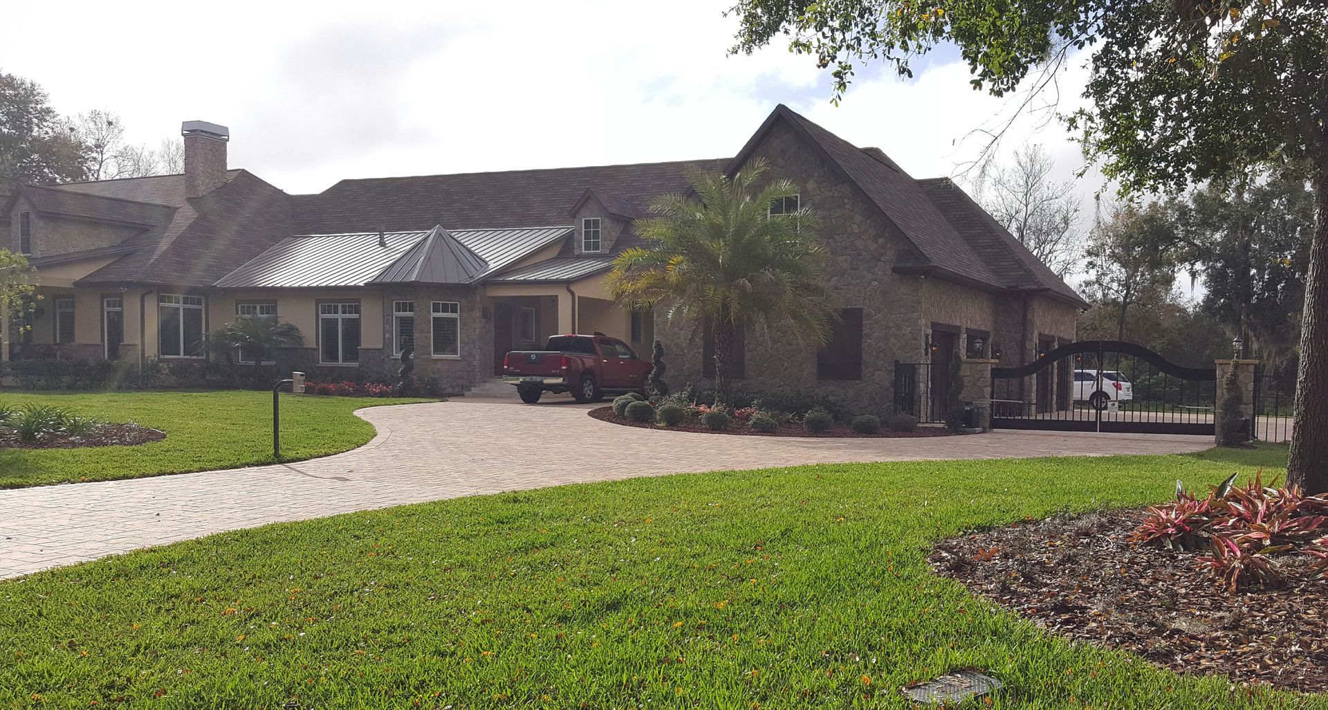 A large house with a red truck parked in front of it