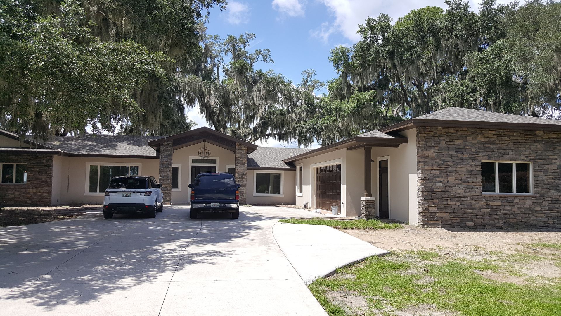A white truck is parked in front of a house.
