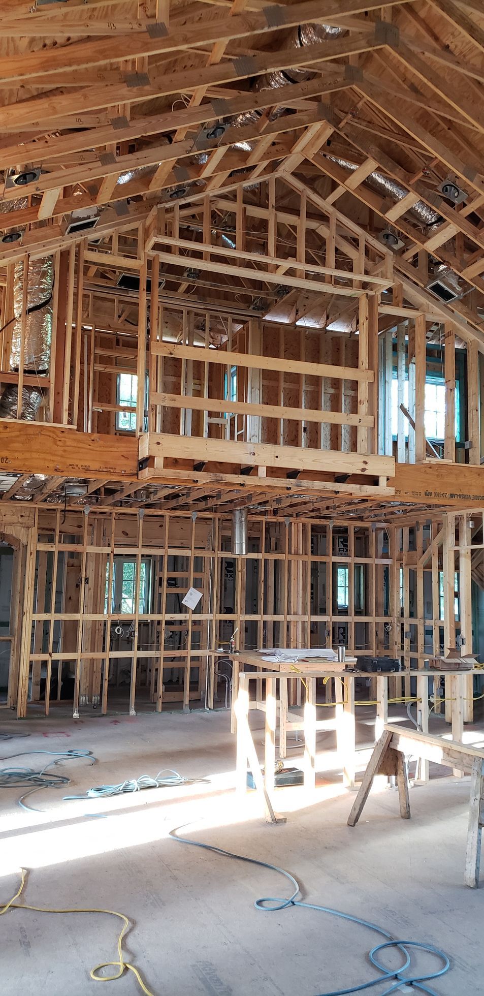 The inside of a building under construction with wooden beams.