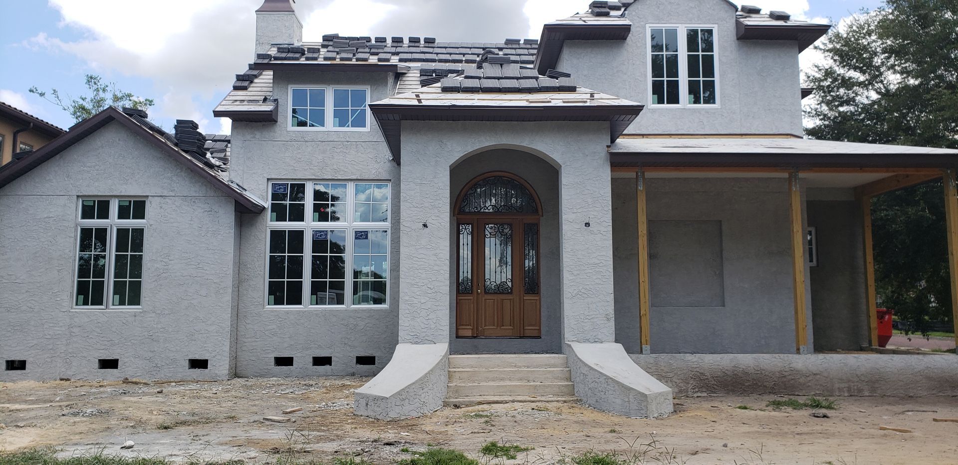 A house that is being built with a lot of windows