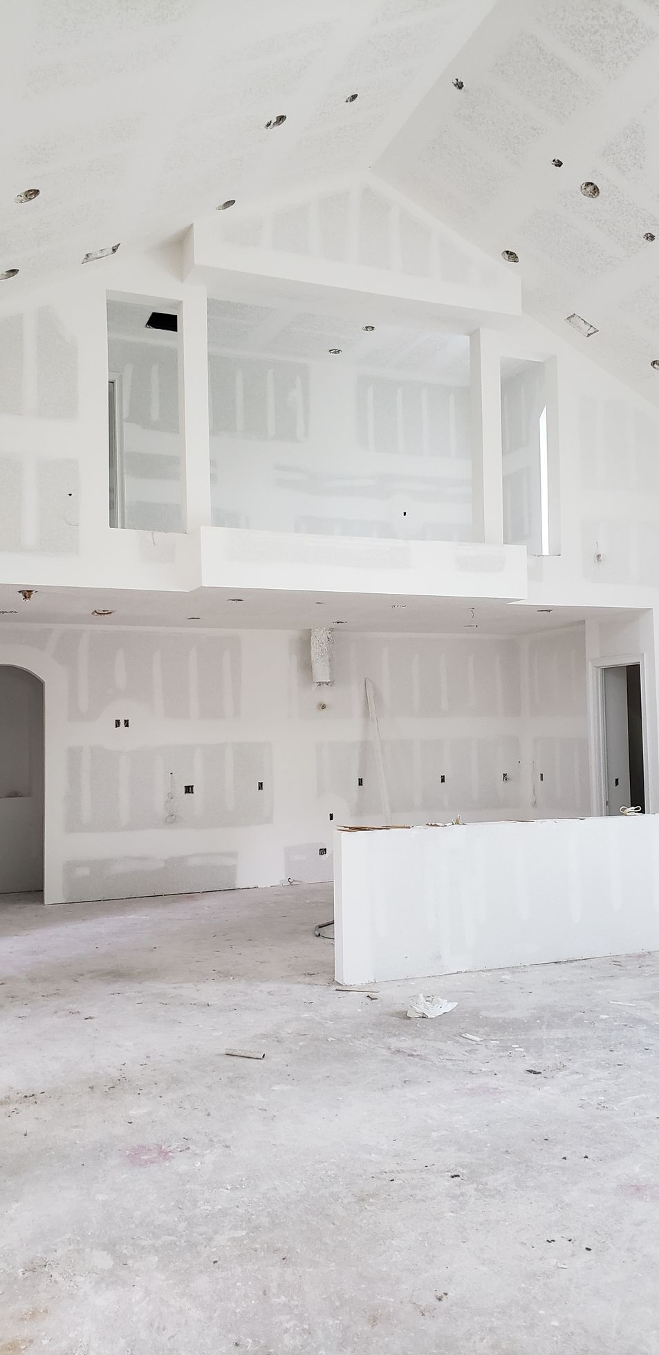 A large empty room with white walls and a ceiling.