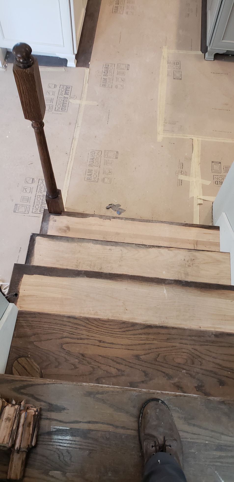 A person is standing on a set of wooden stairs.