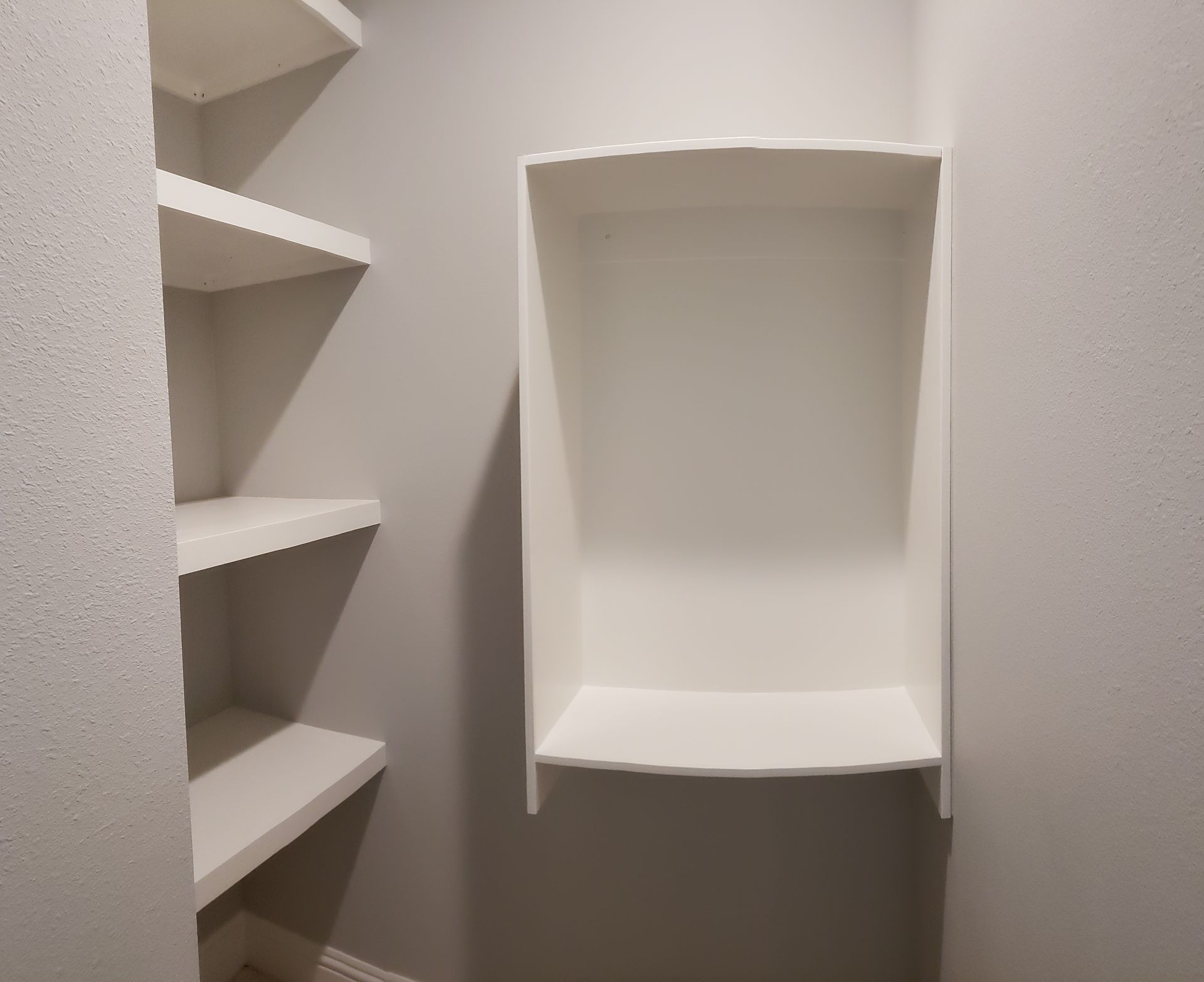 A closet with shelves and a shelf that is empty