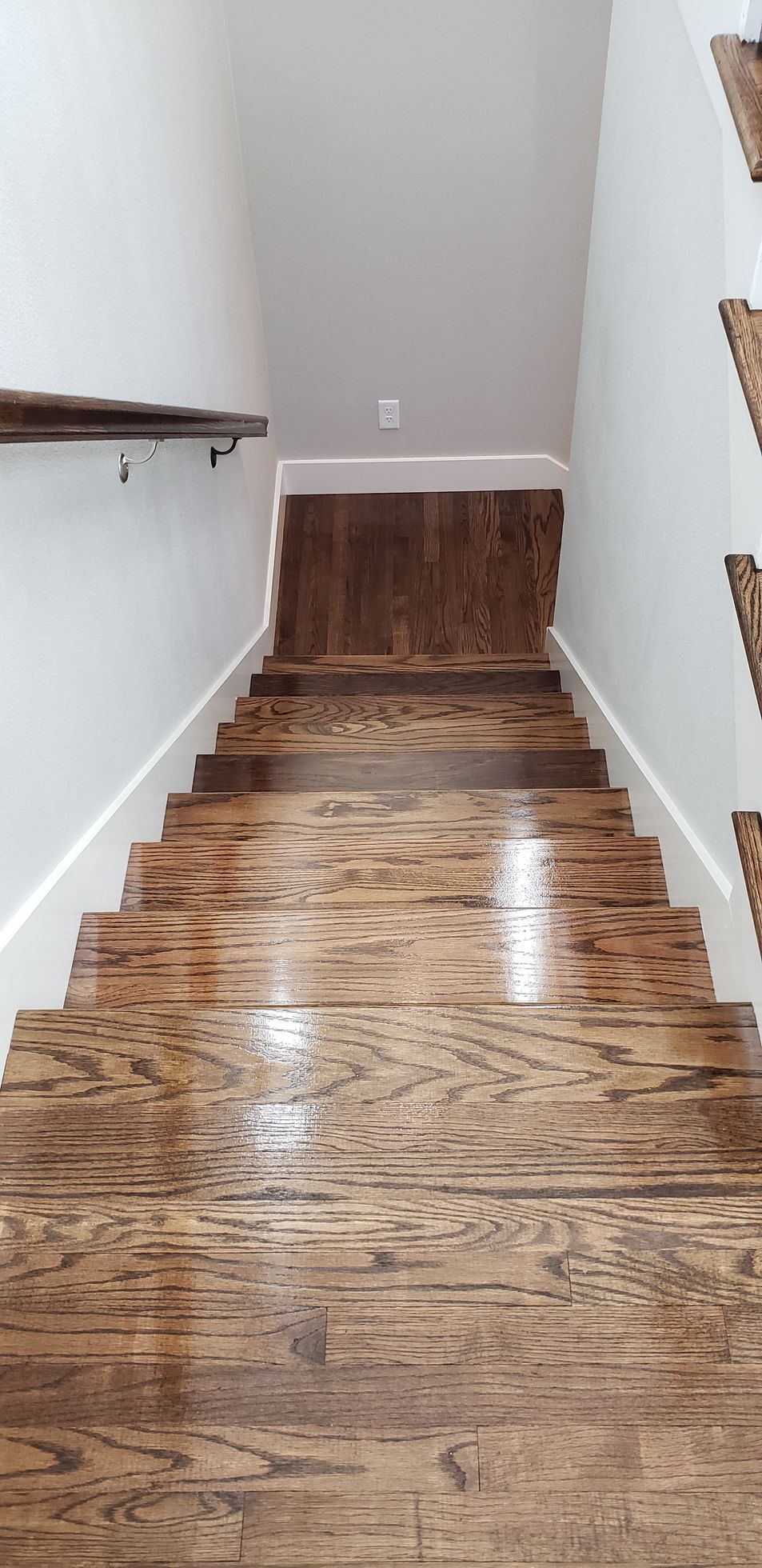 A set of wooden stairs leading up to the second floor of a house.