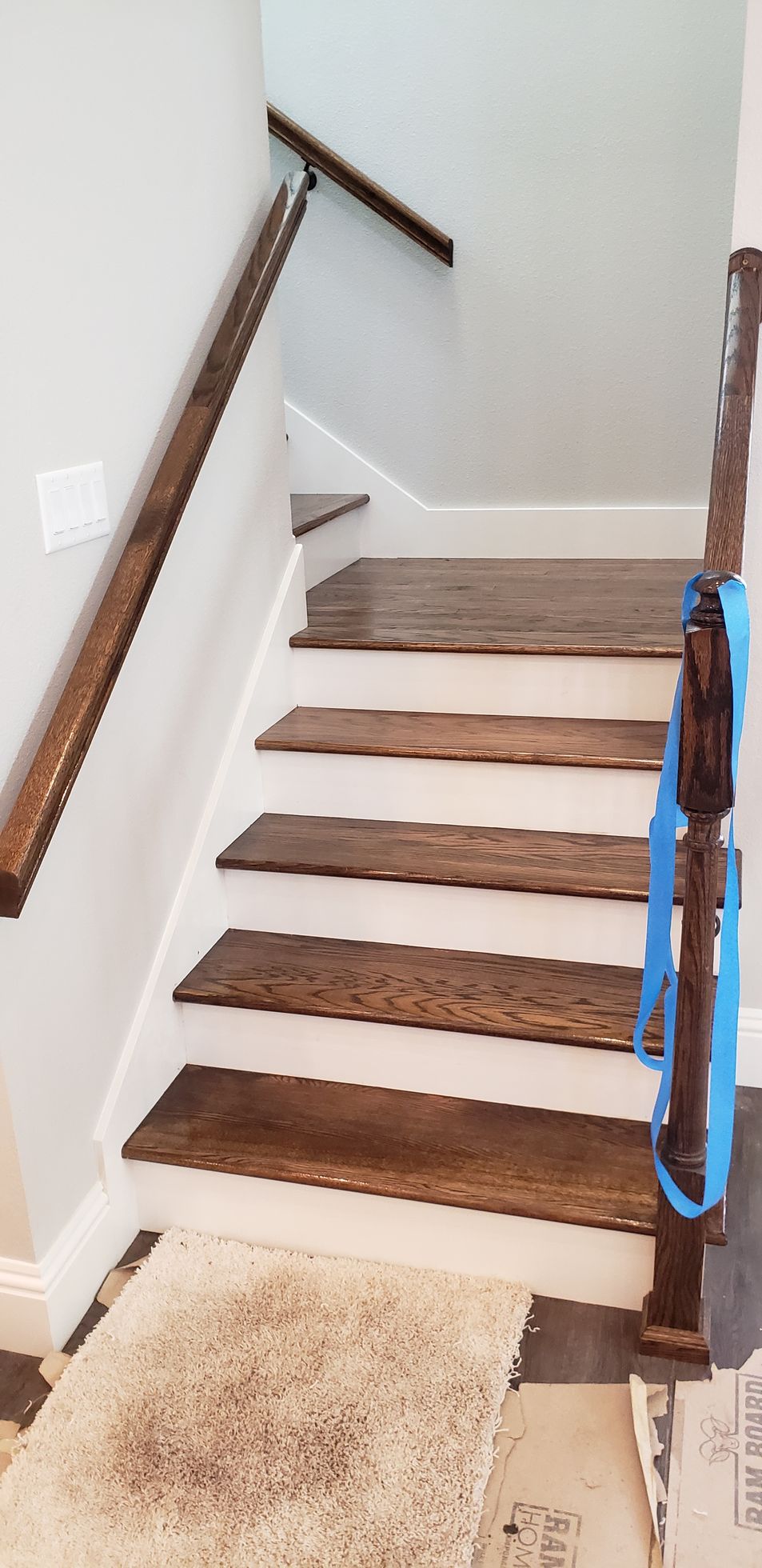A staircase with wooden steps and a wooden railing in a house.