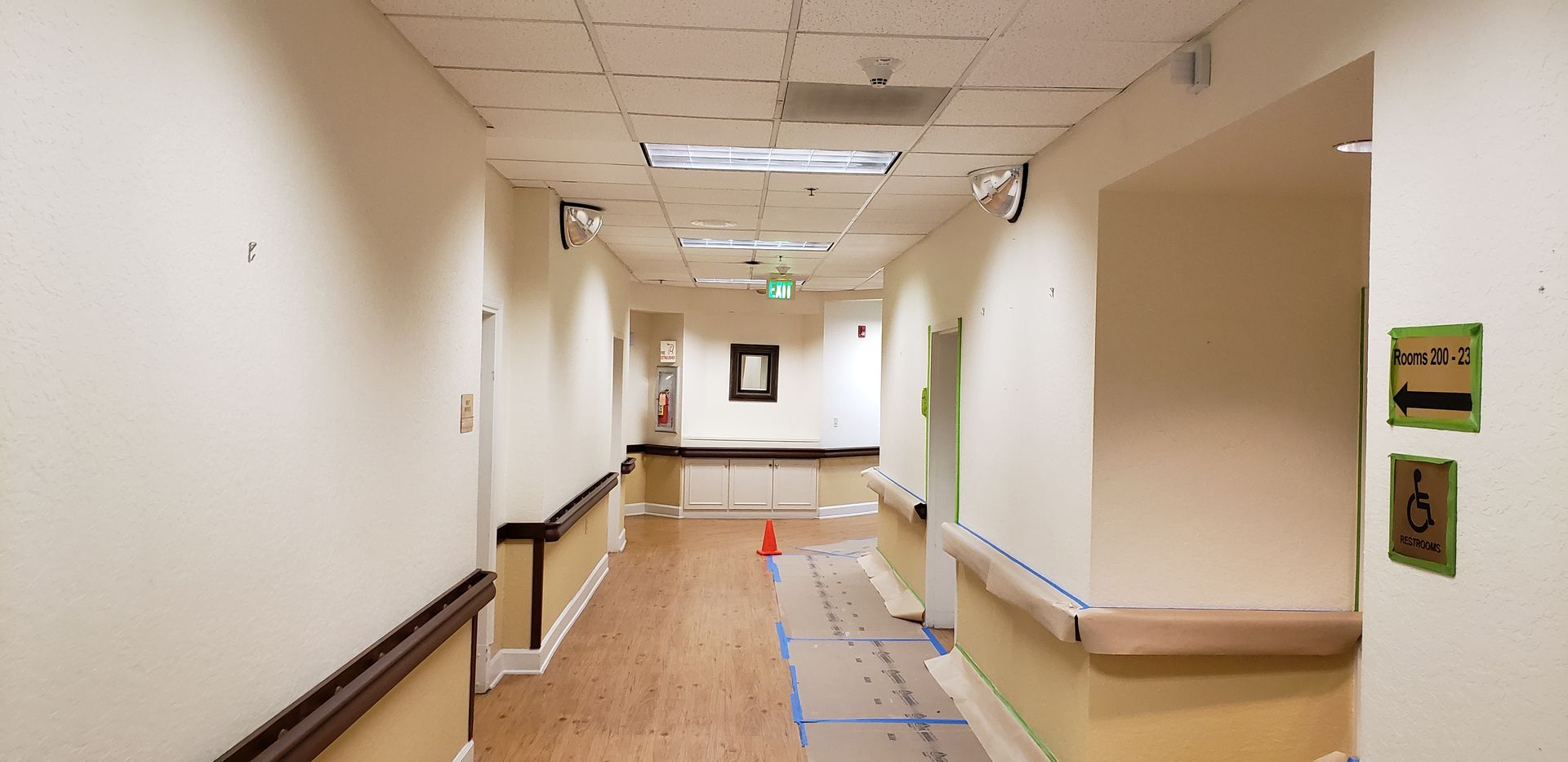 An empty hospital hallway with a handicap sign on the wall.