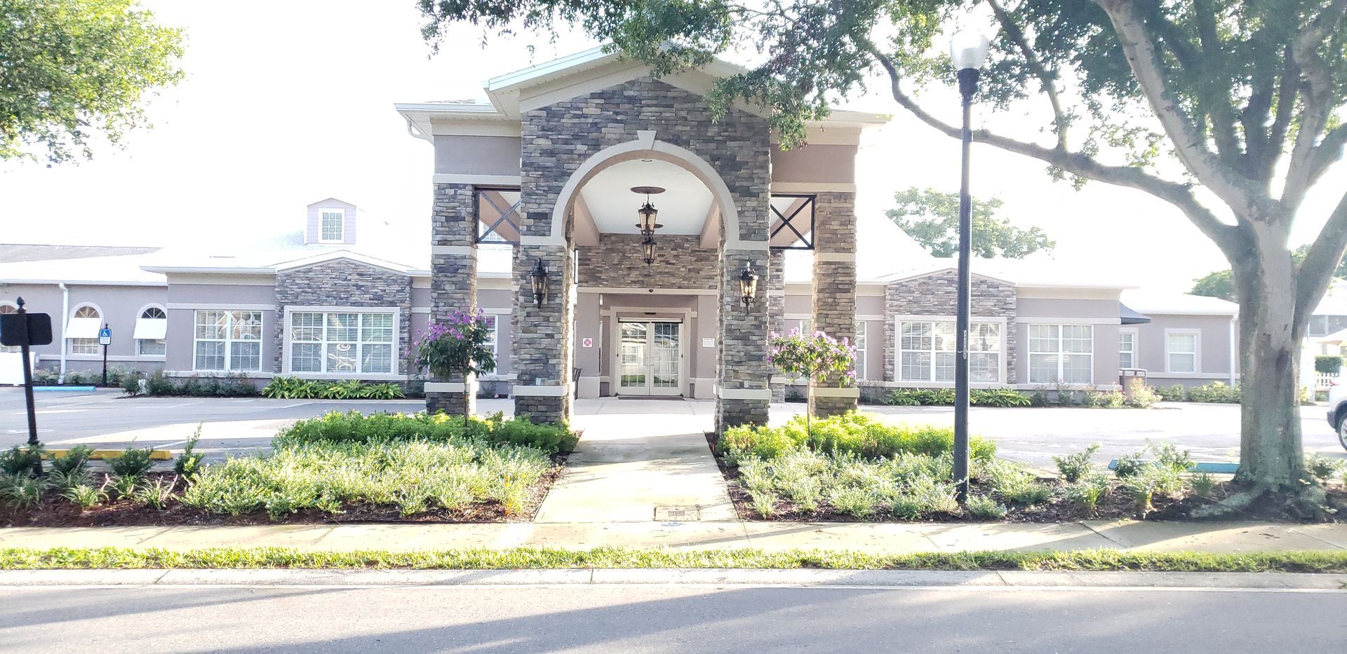 A large building with a lot of windows and trees in front of it.