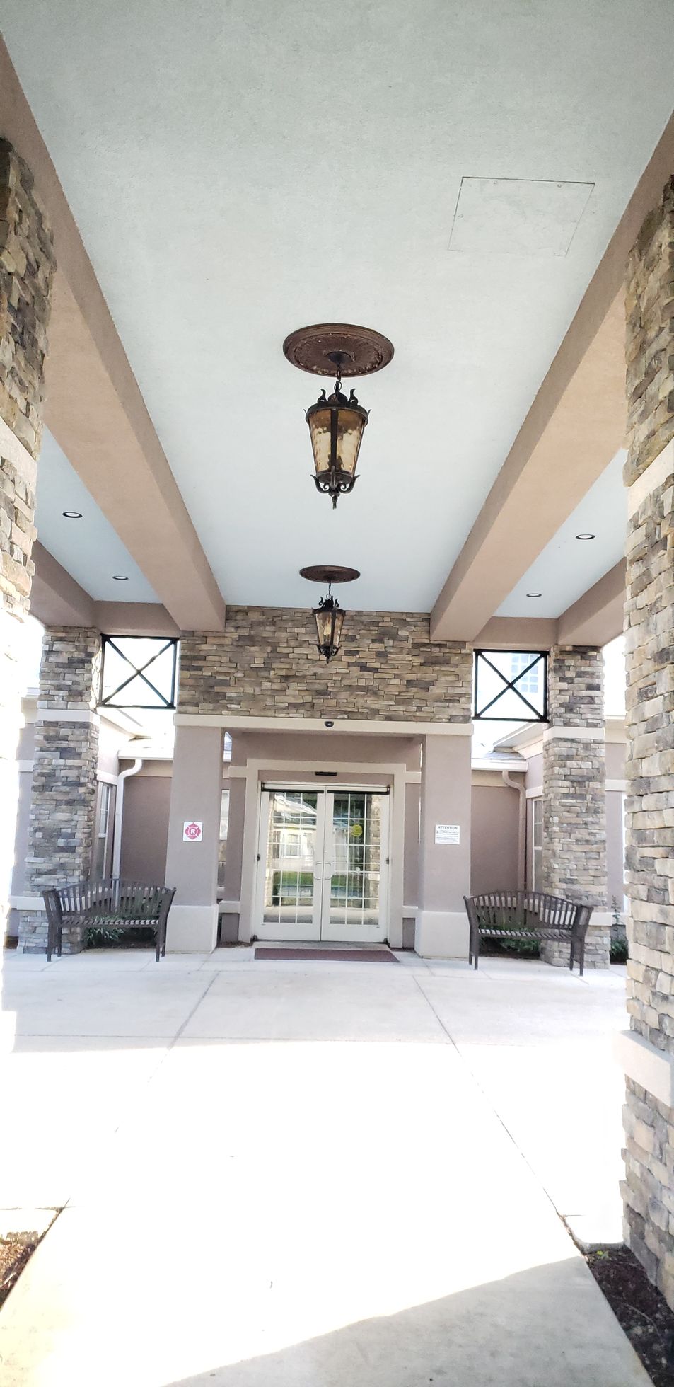 The entrance to a building with a lantern hanging from the ceiling.
