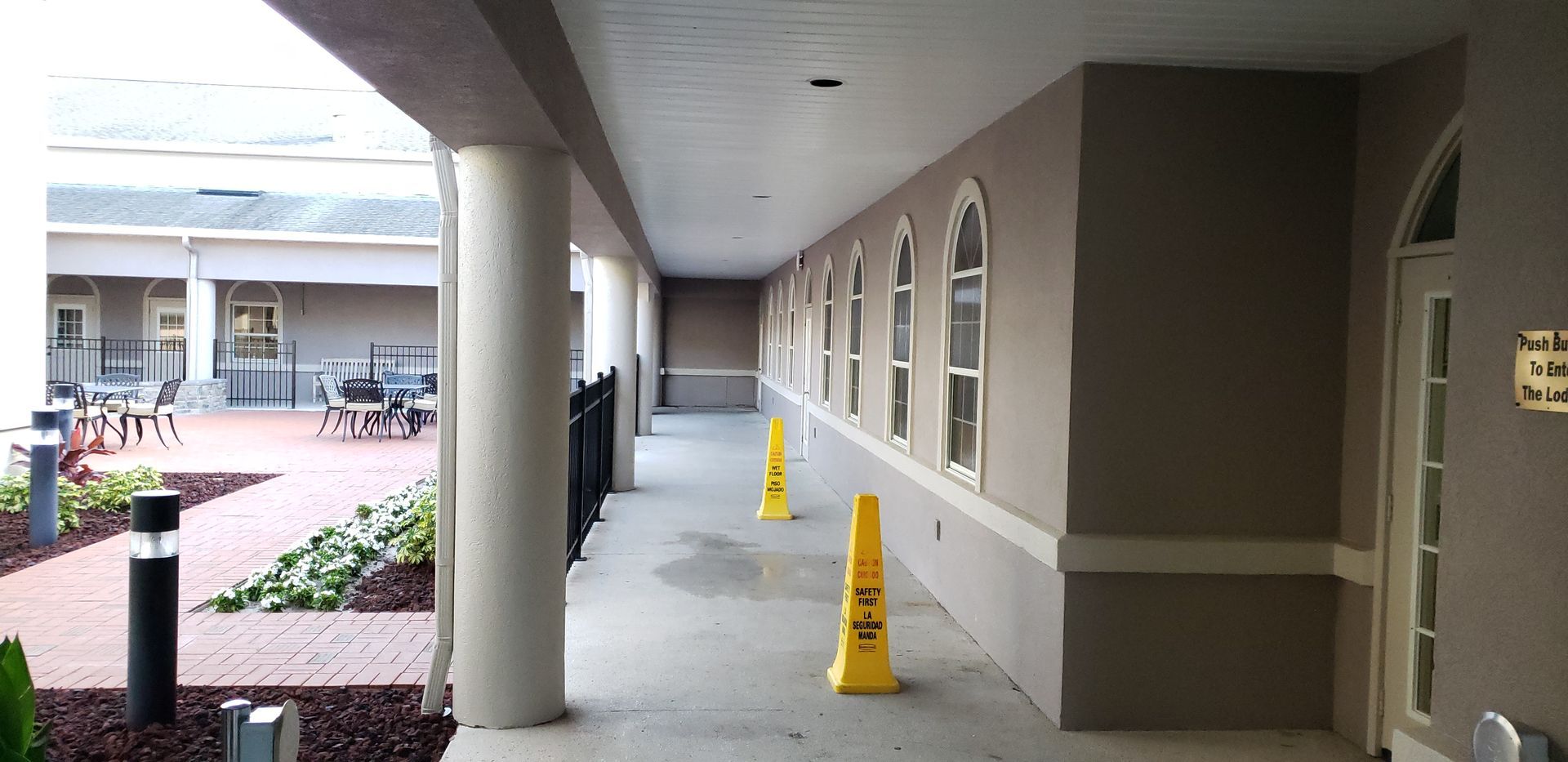 A long hallway with tables and chairs in the background