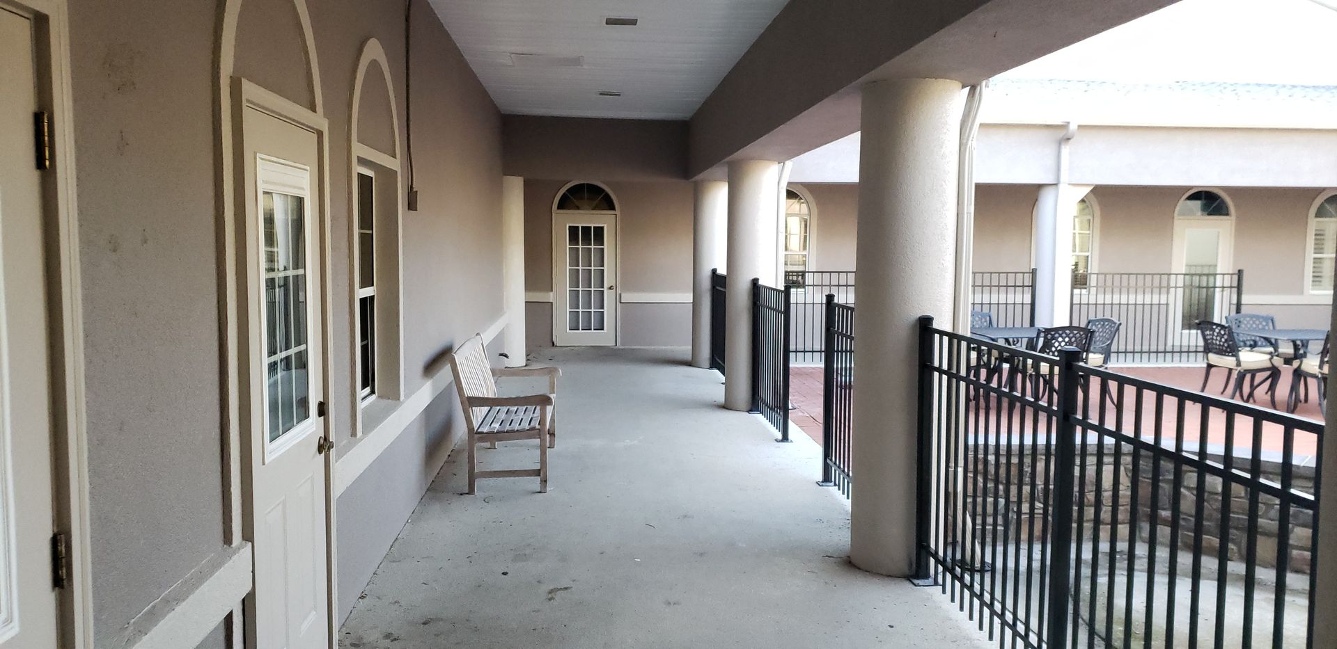 A long hallway with a bench in the middle of it