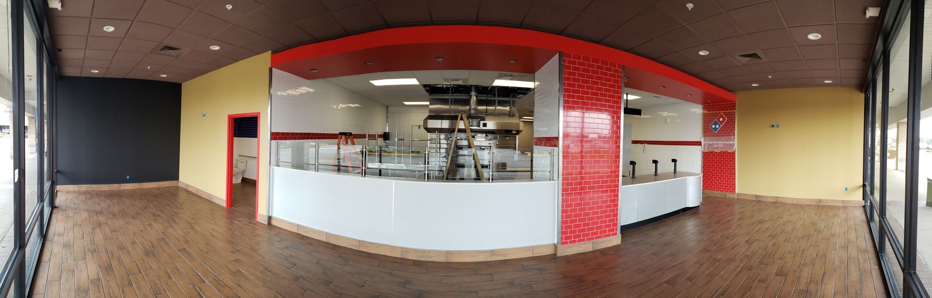 A panoramic view of an empty restaurant with a large counter.