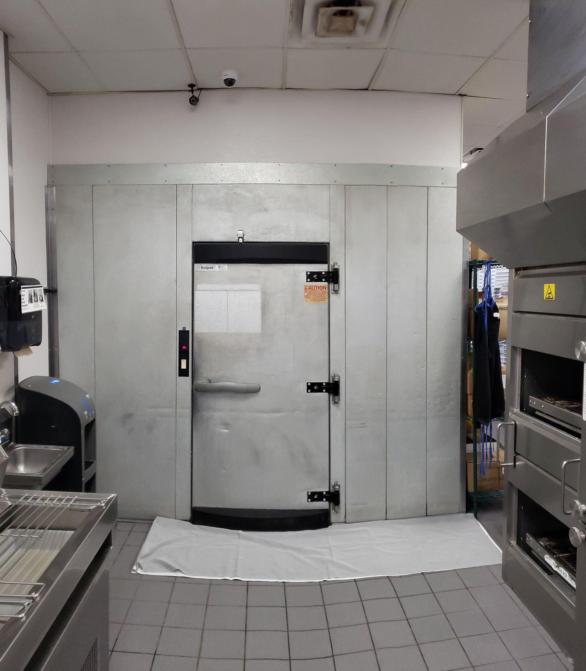 A kitchen with stainless steel appliances and a large door