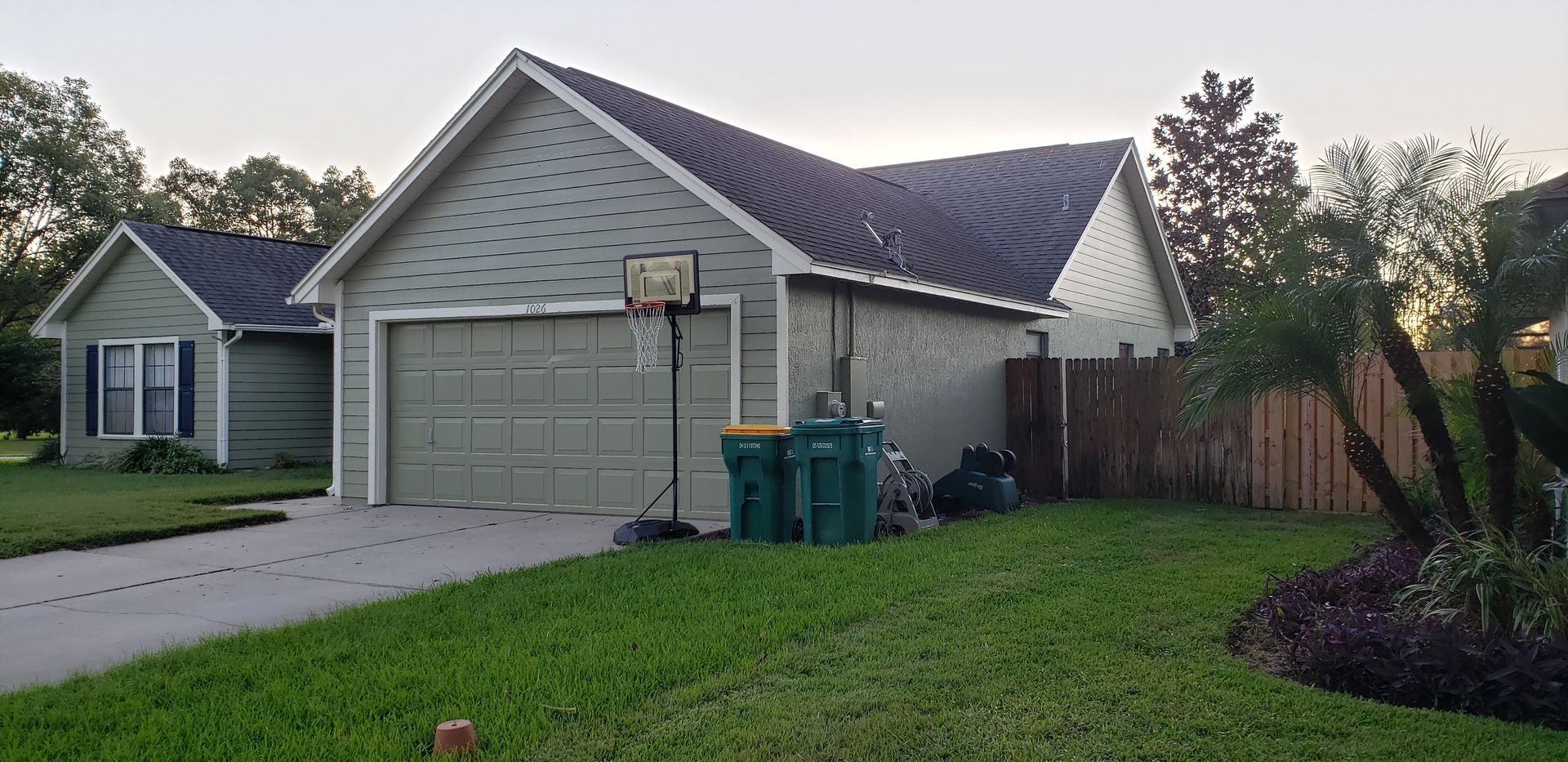 A house with a basketball hoop in front of it.