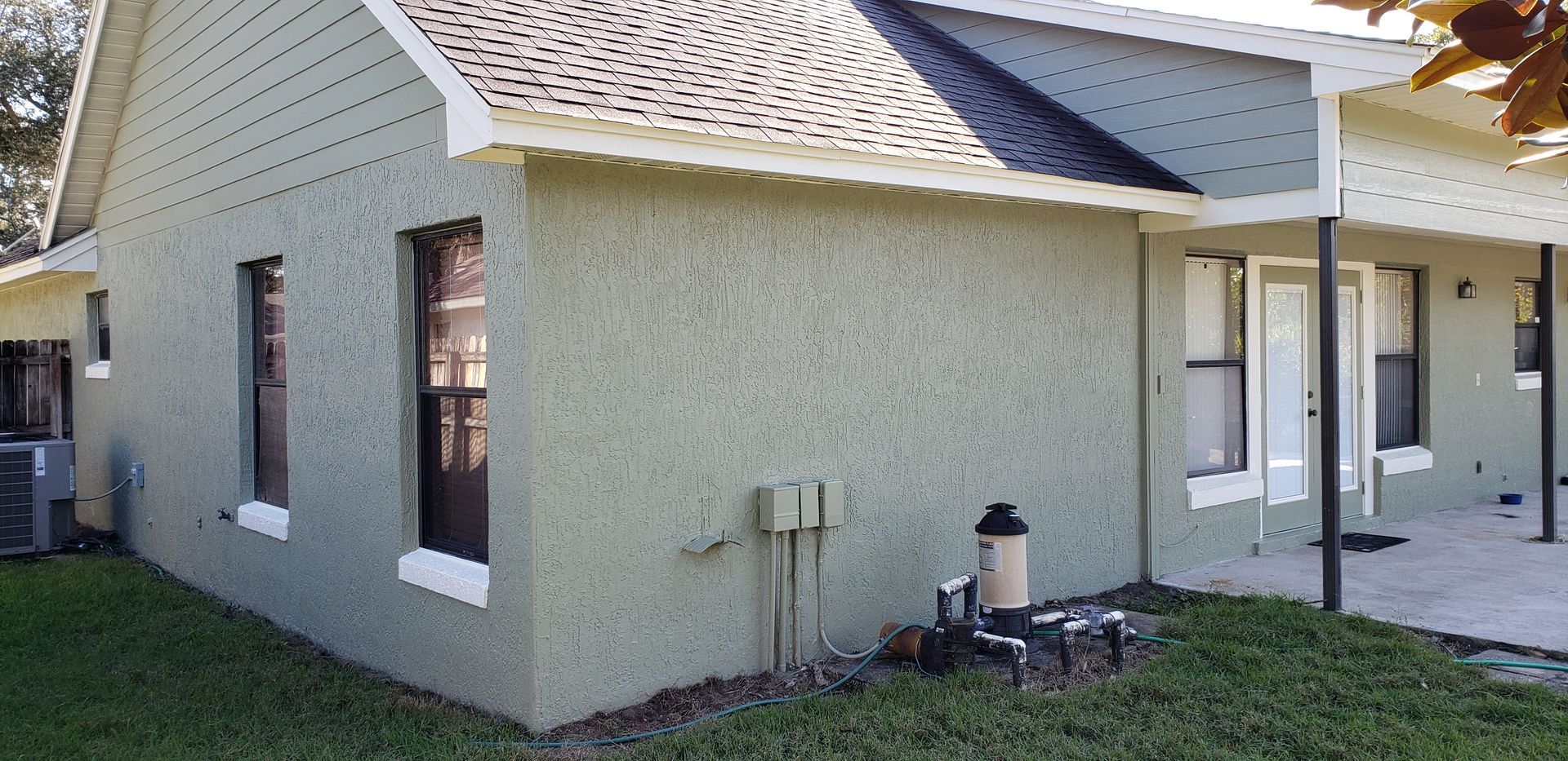 The side of a house with a porch and a roof.