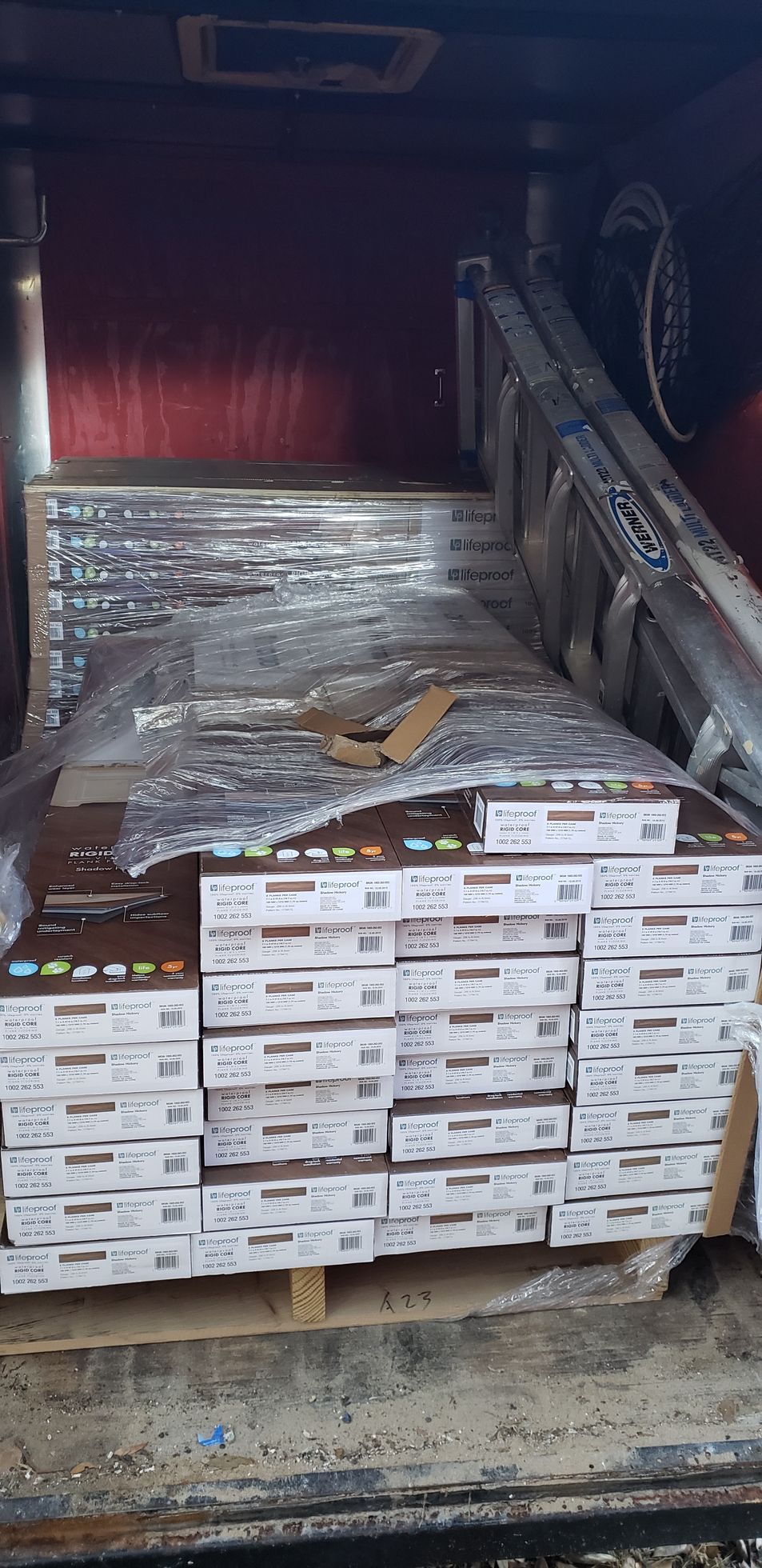 A stack of boxes sitting on top of a wooden pallet.