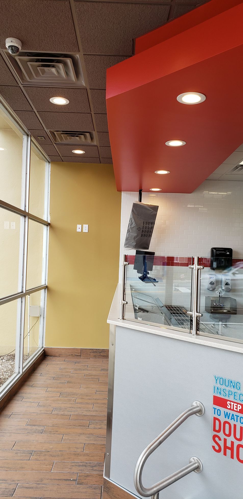 A domino 's pizza restaurant with a red ceiling and a white counter.