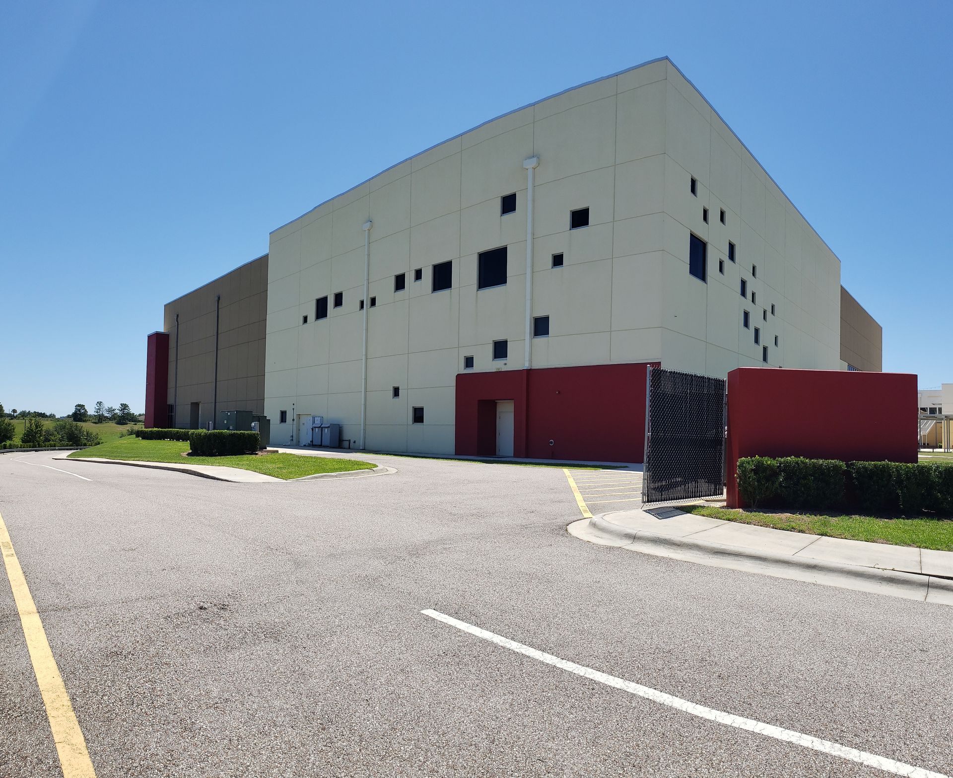 A large white building with a red fence in front of it