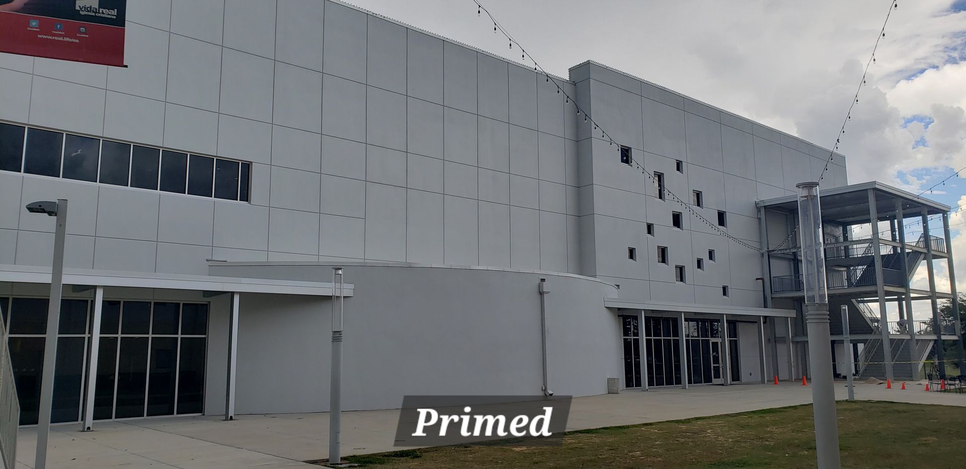 A large white building with a sign that says primed on it.