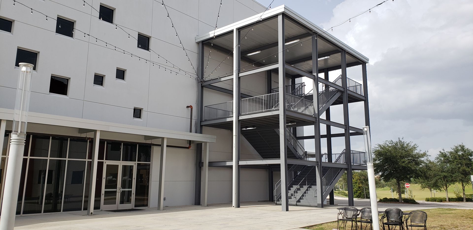 A large building with stairs leading up to it is under construction.