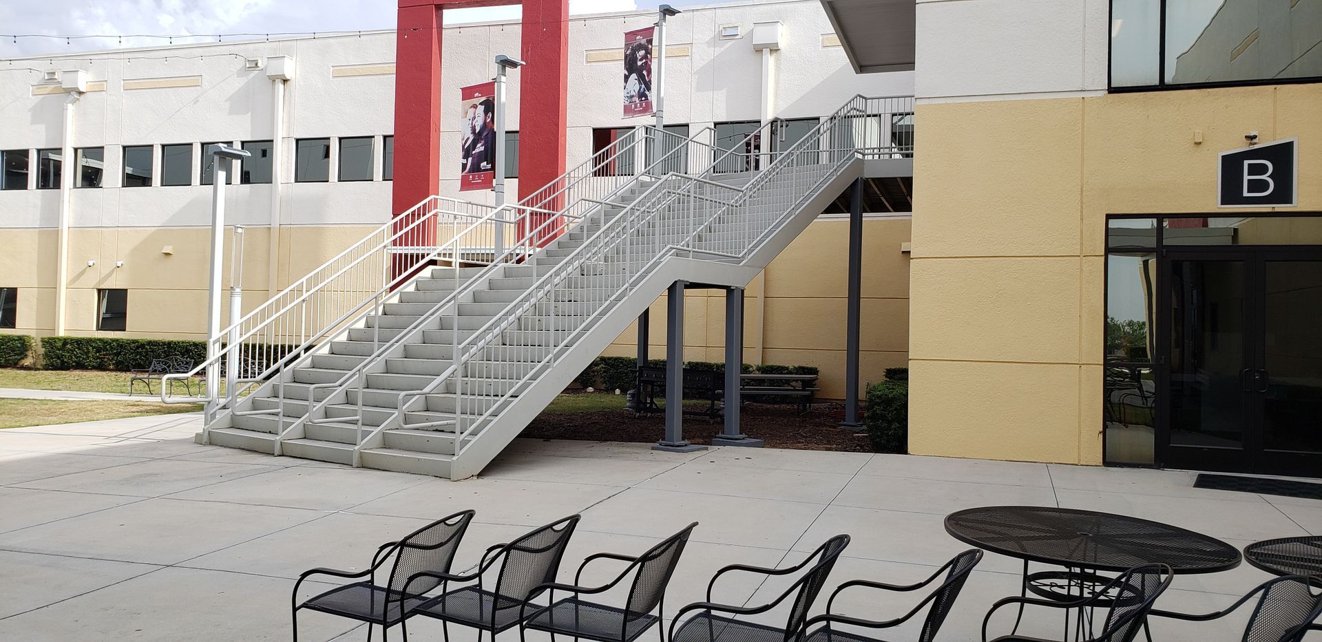 A building with stairs and chairs in front of it