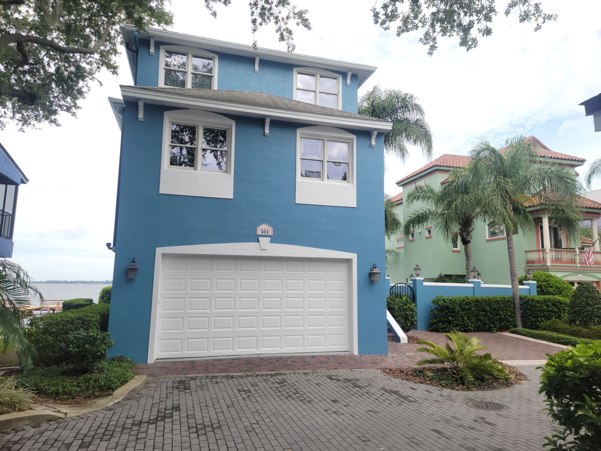 A blue house with a white garage door