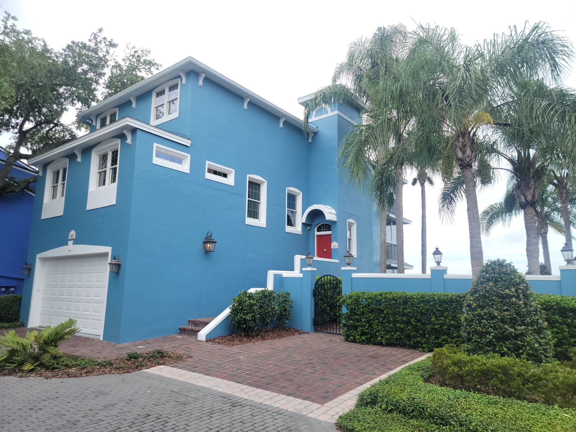 A blue house with white trim and a red door