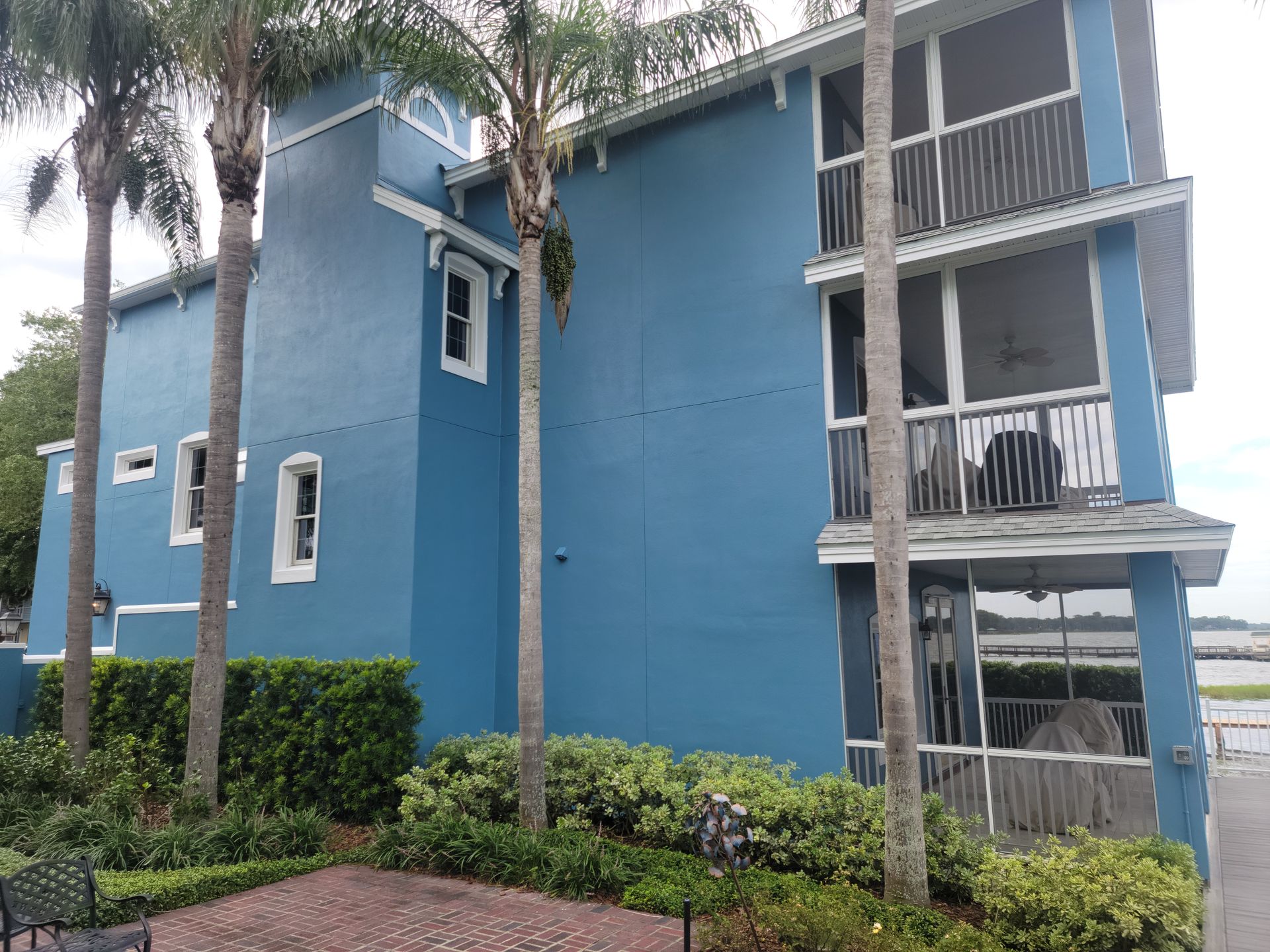 A blue building with palm trees in front of it