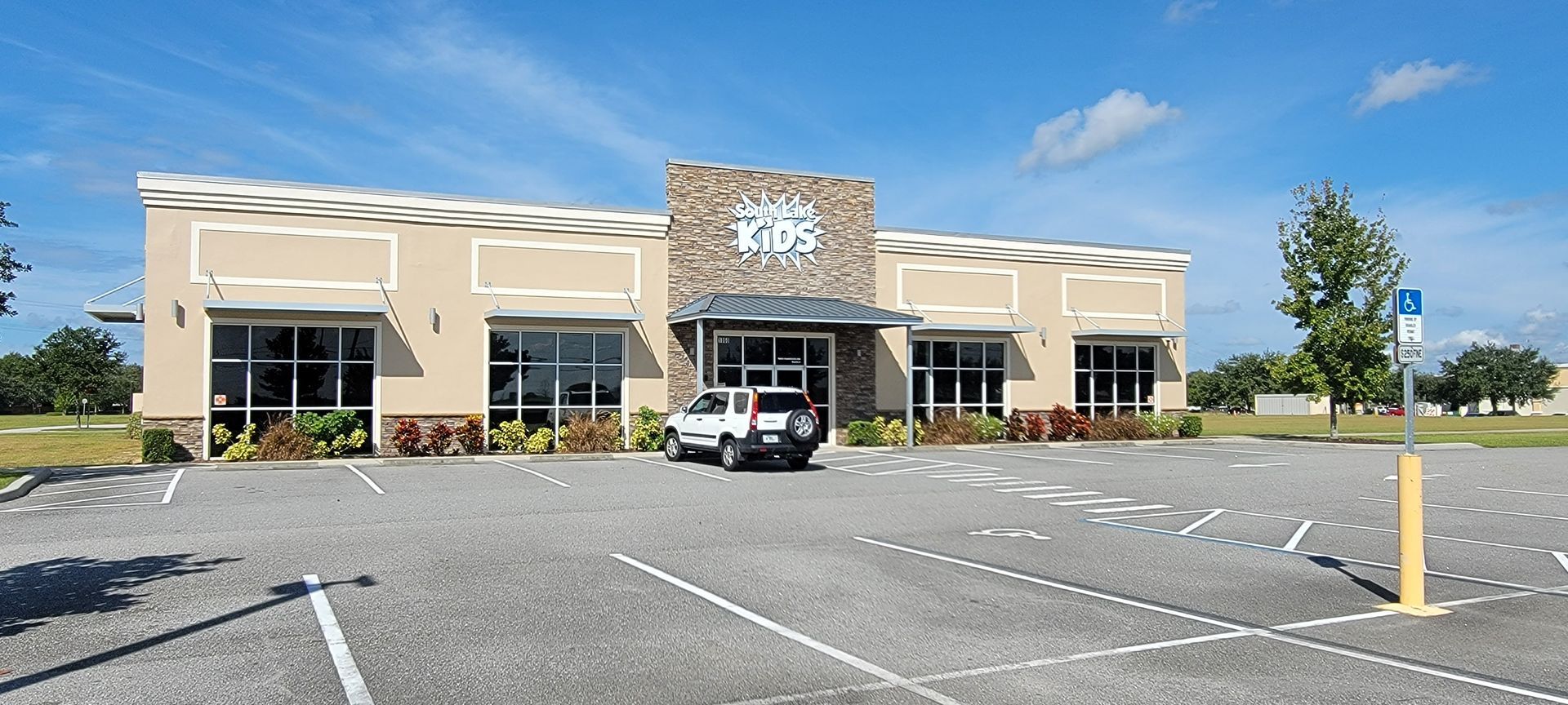 A car is parked in front of a large building