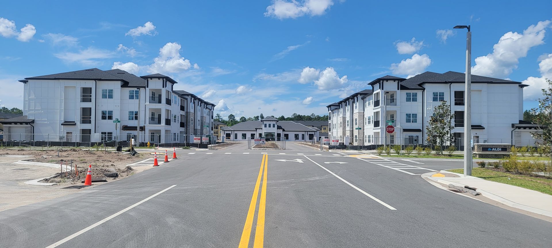 A large apartment complex is being built next to a road.