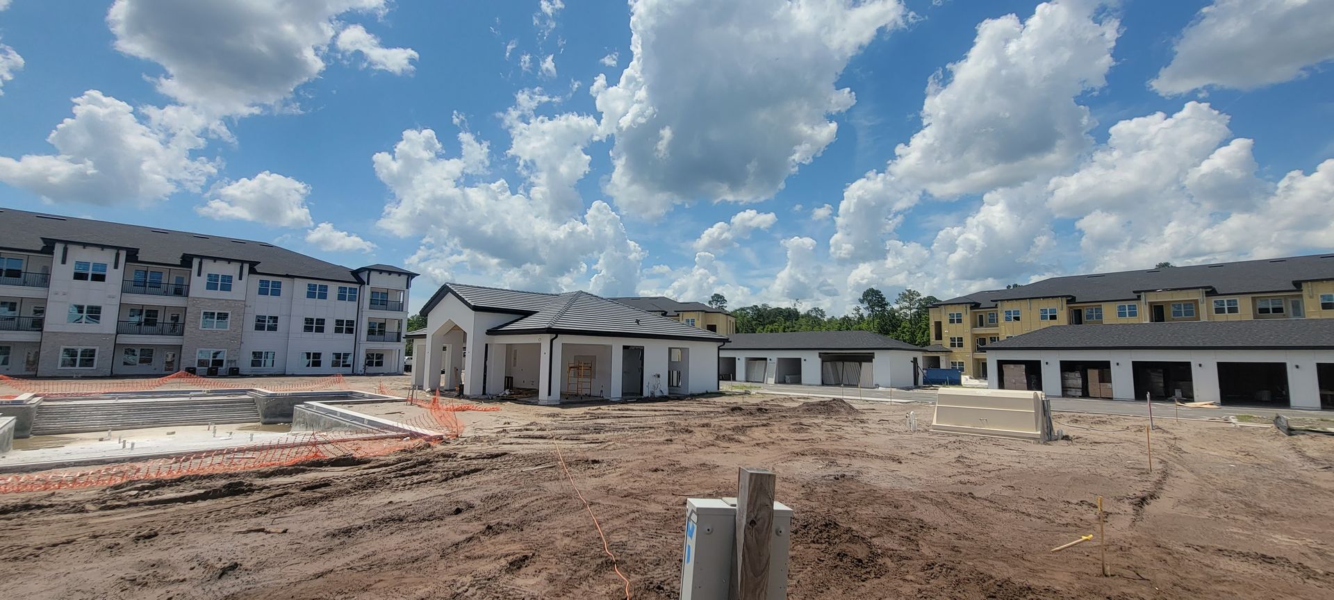 A building under construction with a lot of dirt in front of it.
