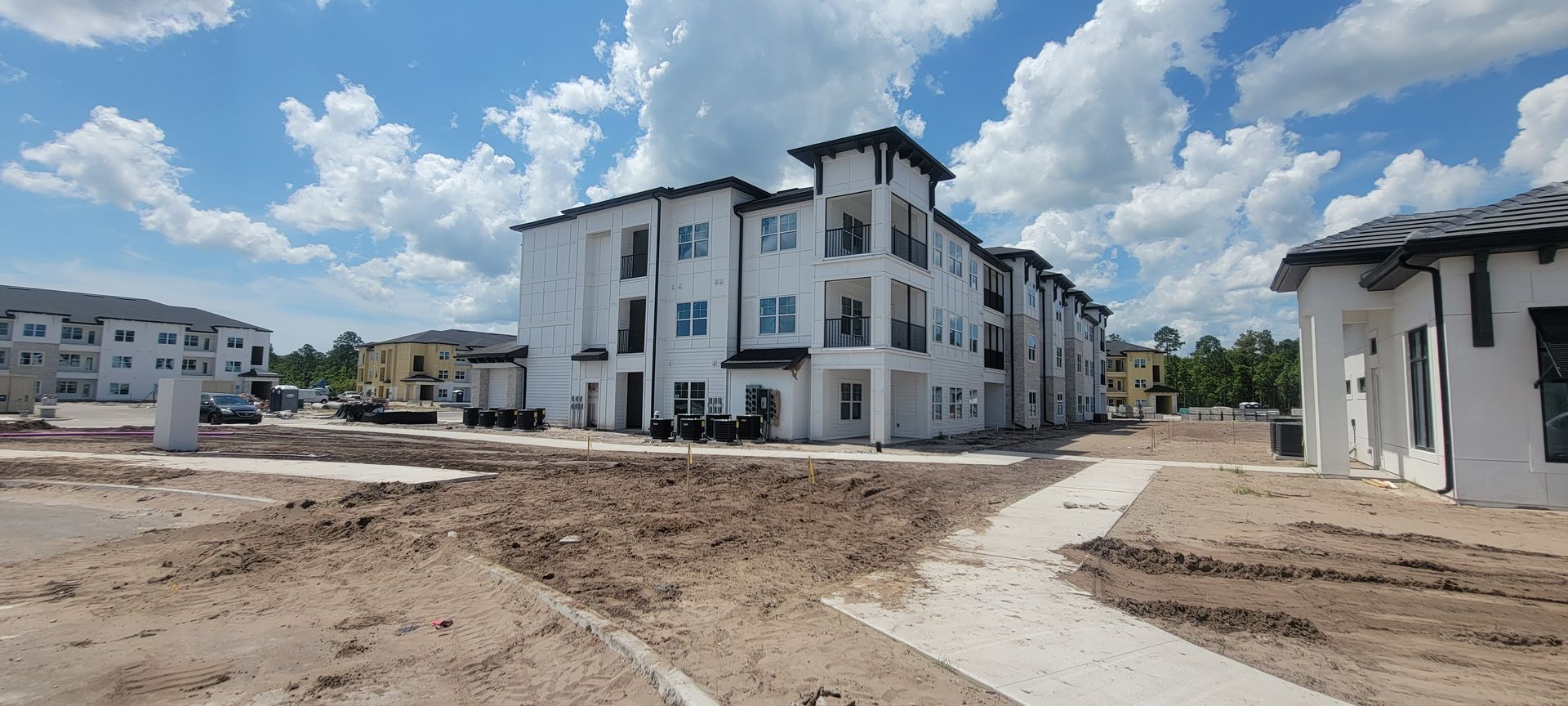 A large apartment building is being built in a residential area.