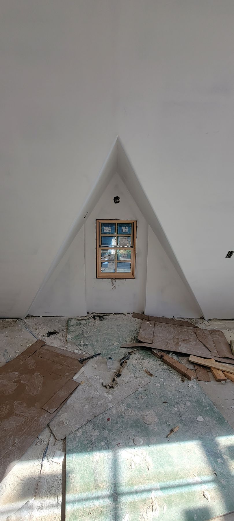 There is a window in the corner of the room.