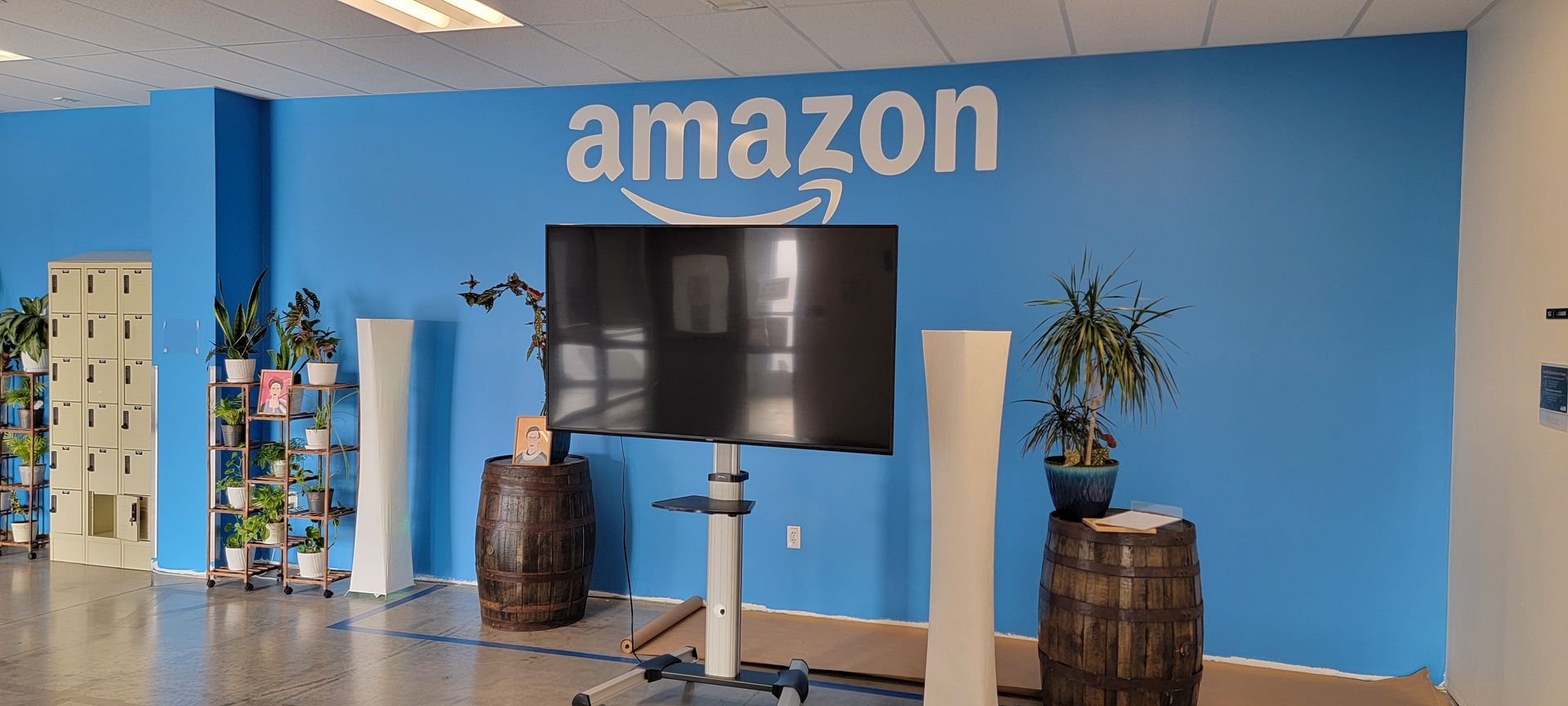 A room with a blue wall and a tv on a stand.