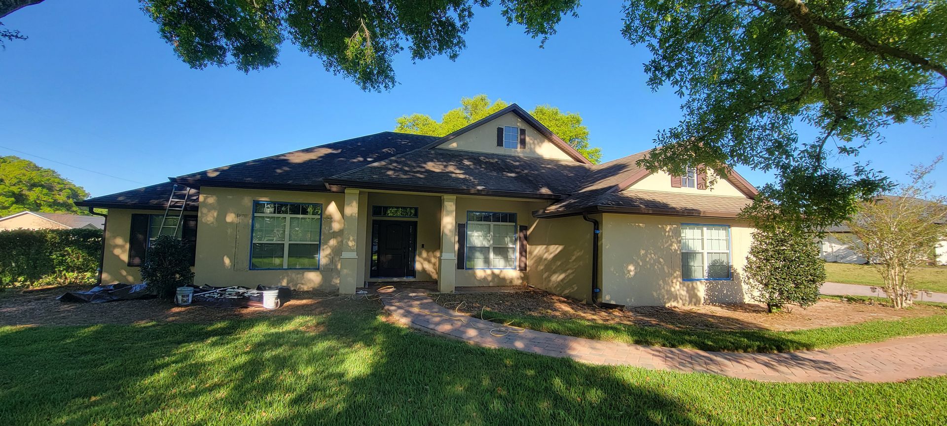 A large house with a lot of windows and a tree in front of it.