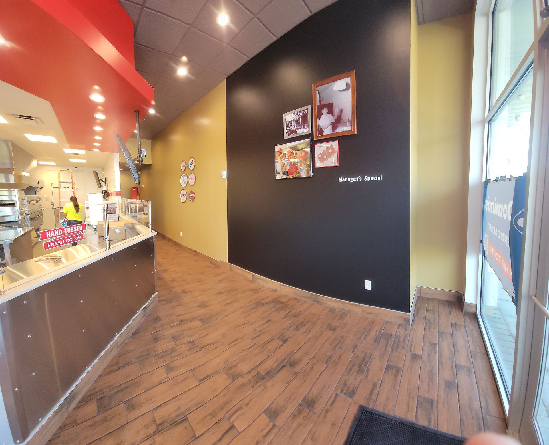 A domino 's pizza restaurant with a black wall