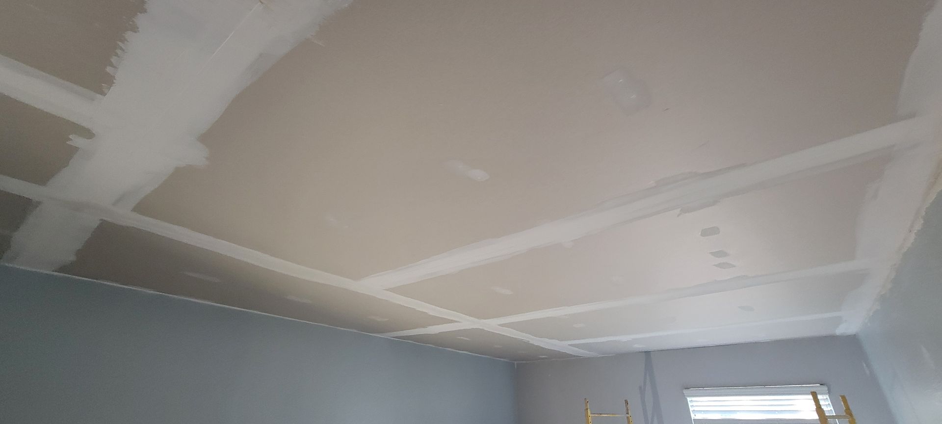 A room with a ceiling that is being remodeled.
