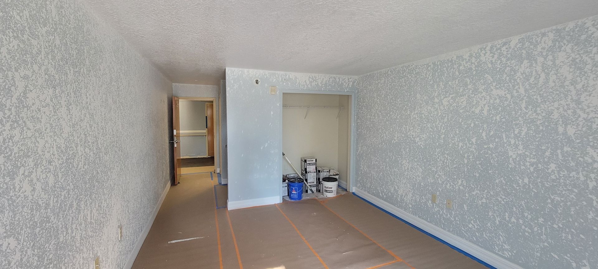 An empty room with a lot of boxes on the floor.