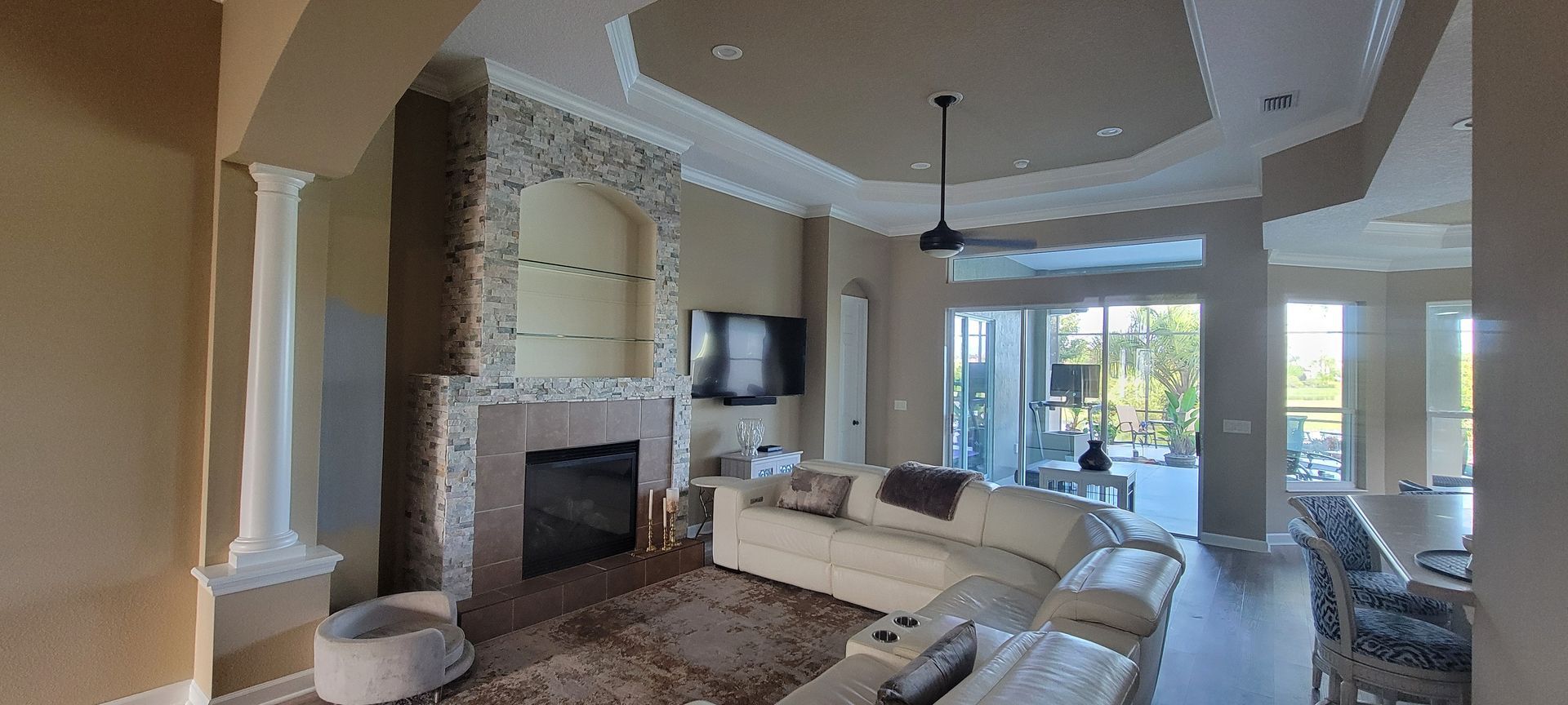 A living room with a fireplace , couch , and television.