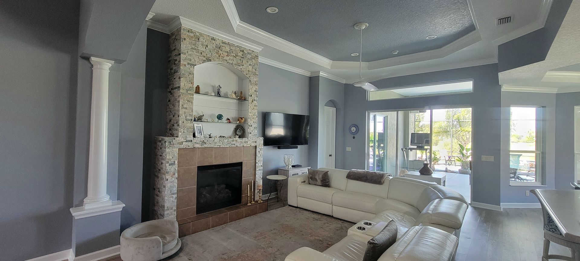 A living room with a fireplace , couch , and television.