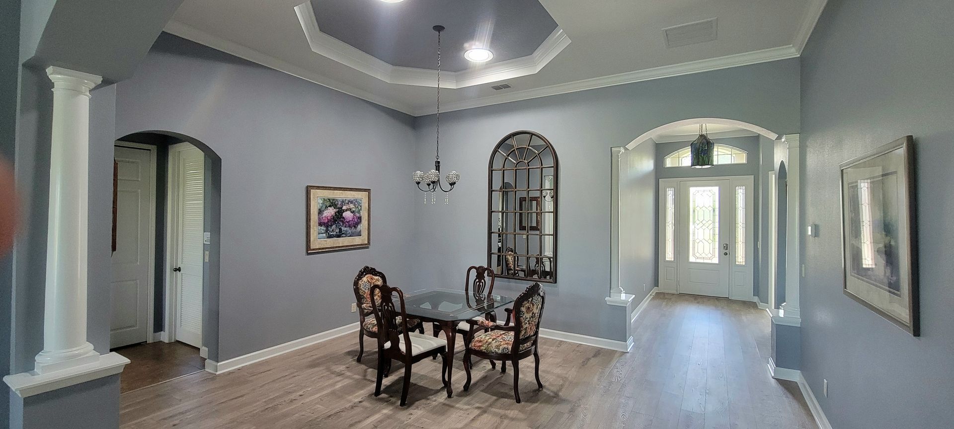 A dining room with a table and chairs in a house.
