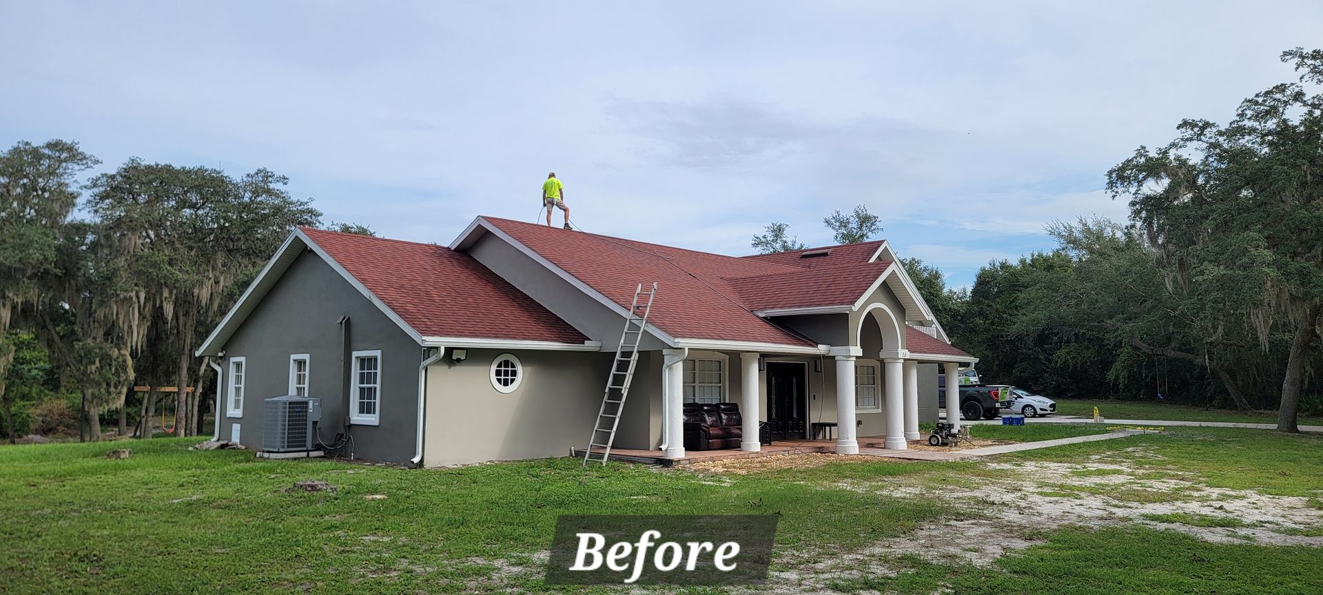 A before picture of a house with a red roof