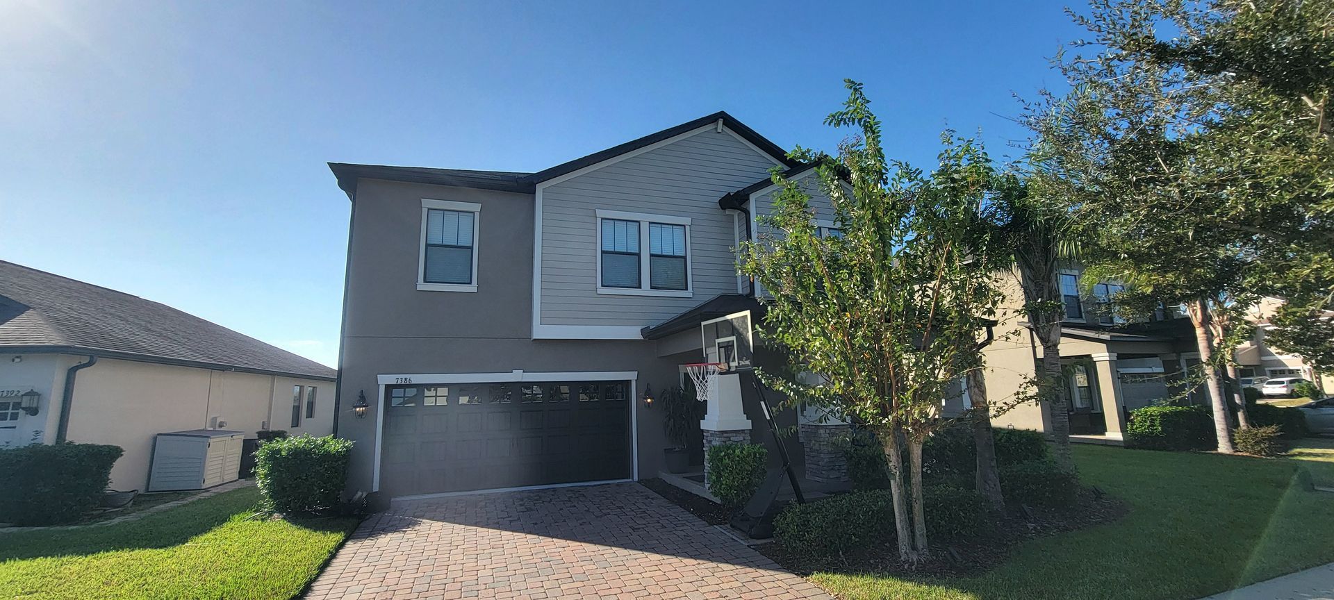 A large house with a garage and a driveway in front of it.