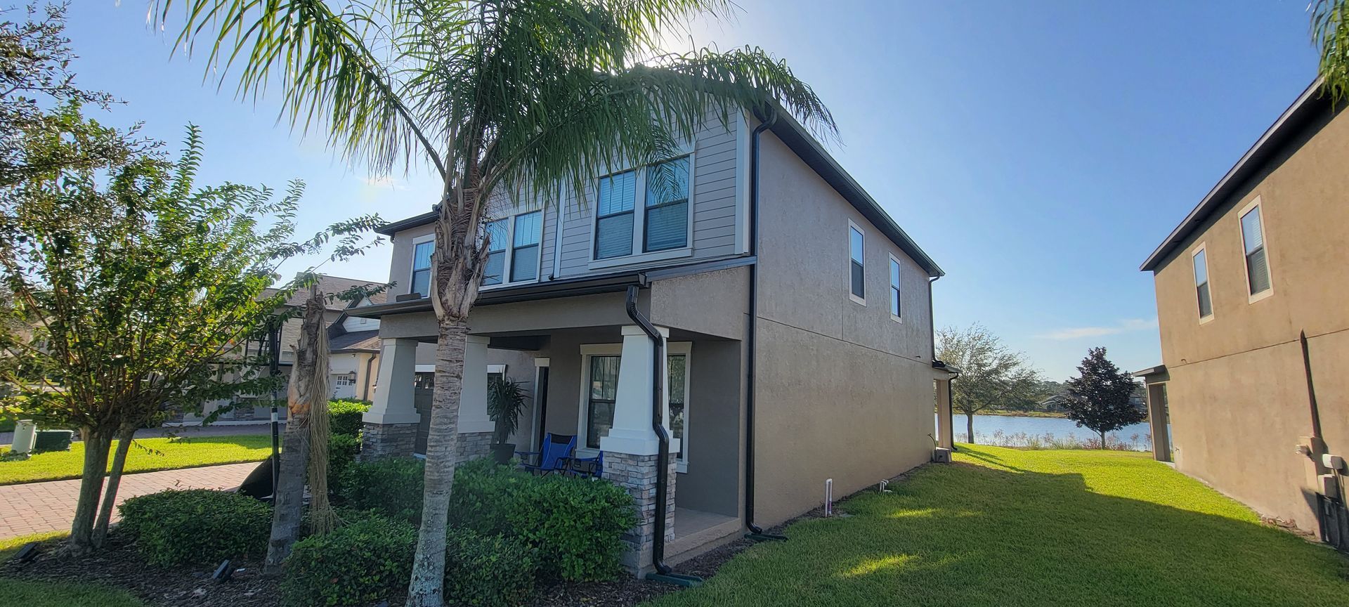 A house with a lot of windows and a tree in front of it.