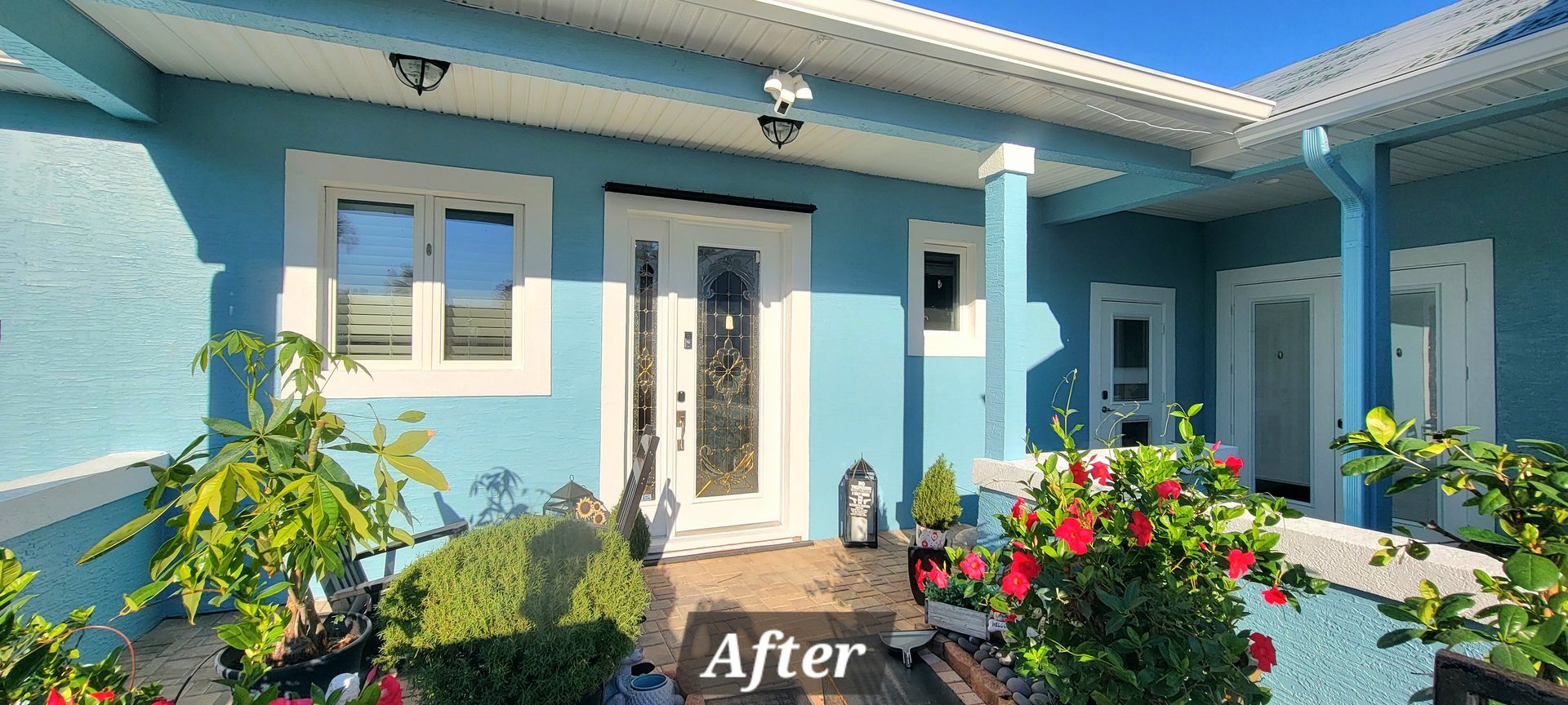 A blue house with white trim and a sign that says `` after ''.