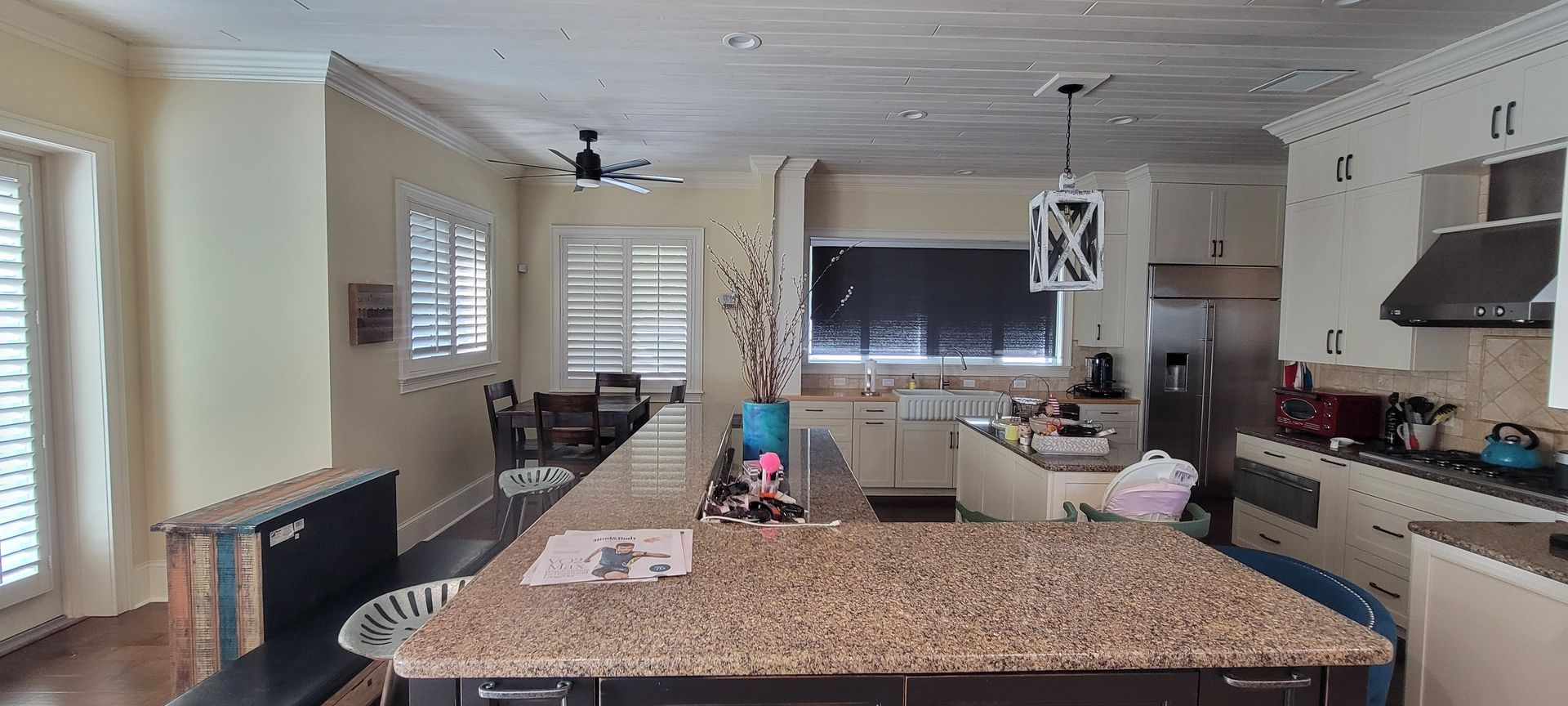A kitchen with granite counter tops and stainless steel appliances.